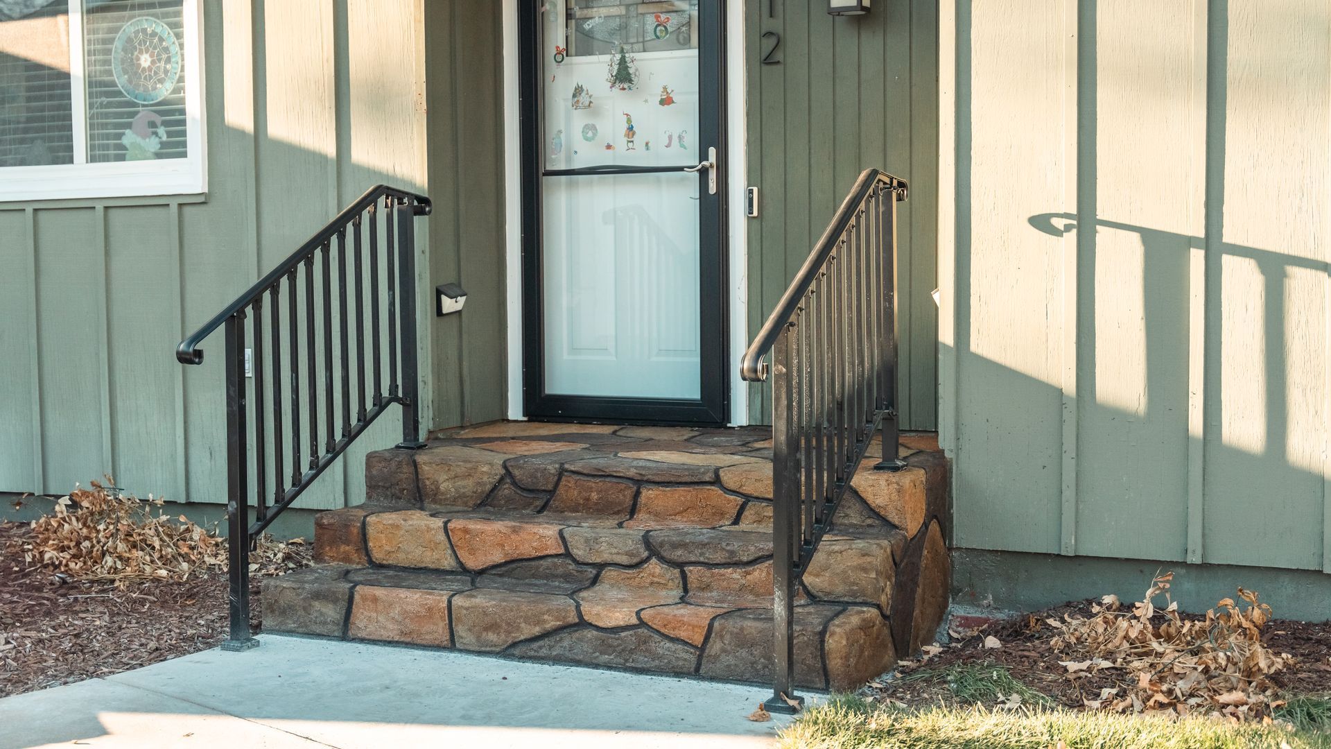 A house with stone steps leading up to the front door