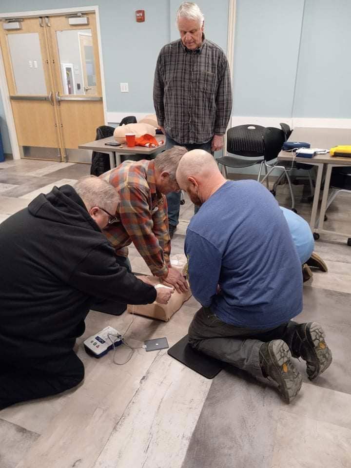 A group of men are kneeling on the floor in a room.