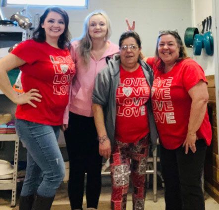 A group of women wearing red shirts that say love