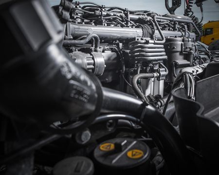 A close up of a car engine with a lot of wires coming out of it.