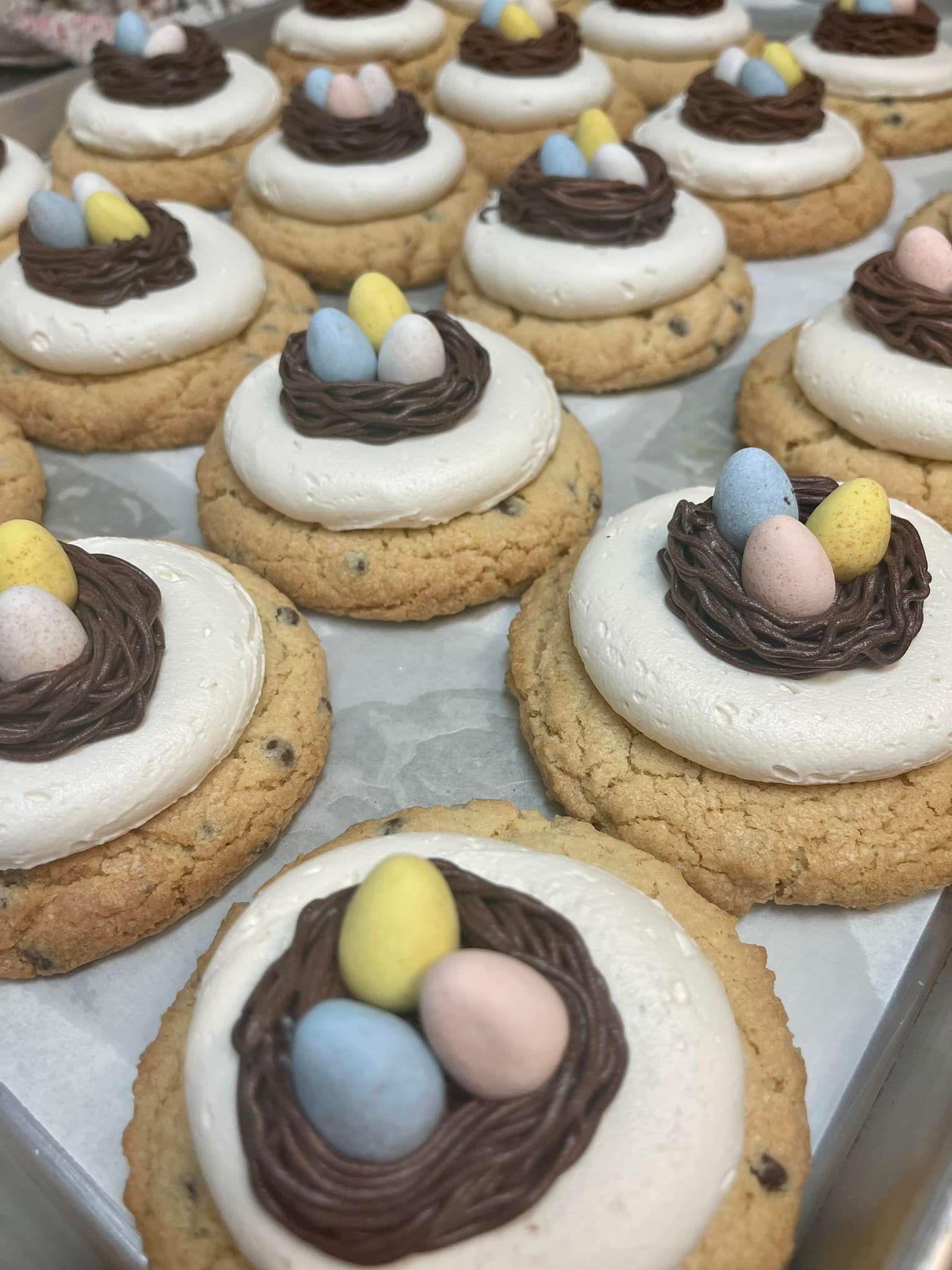 Cookies decorated with nests of chocolate frosting and candy eggs.