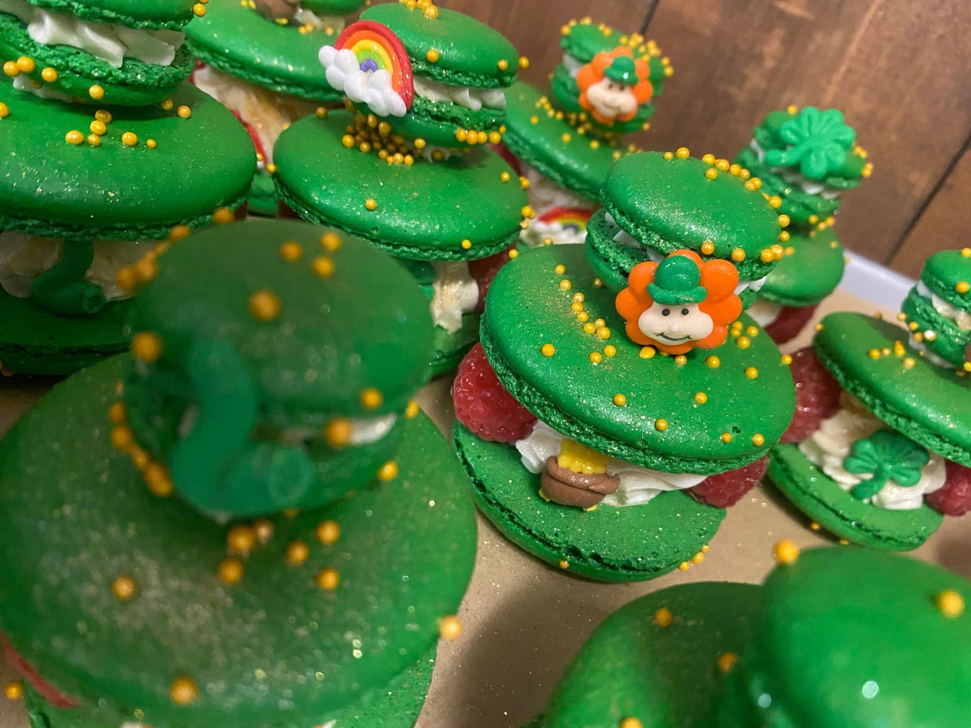 Green macarons decorated with St. Patrick's Day themes.