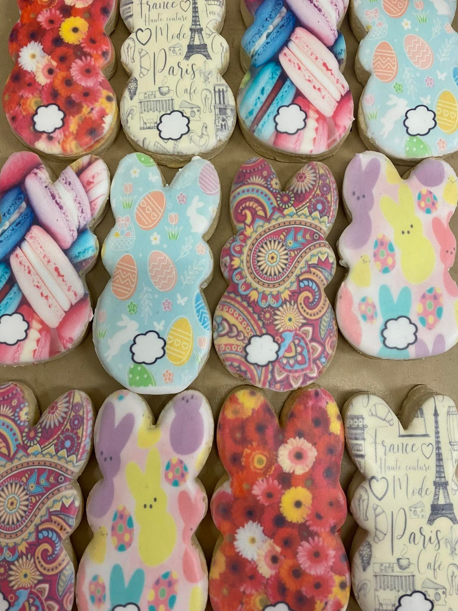 Easter bunny-shaped cookies, decorated with various colorful patterns and designs.