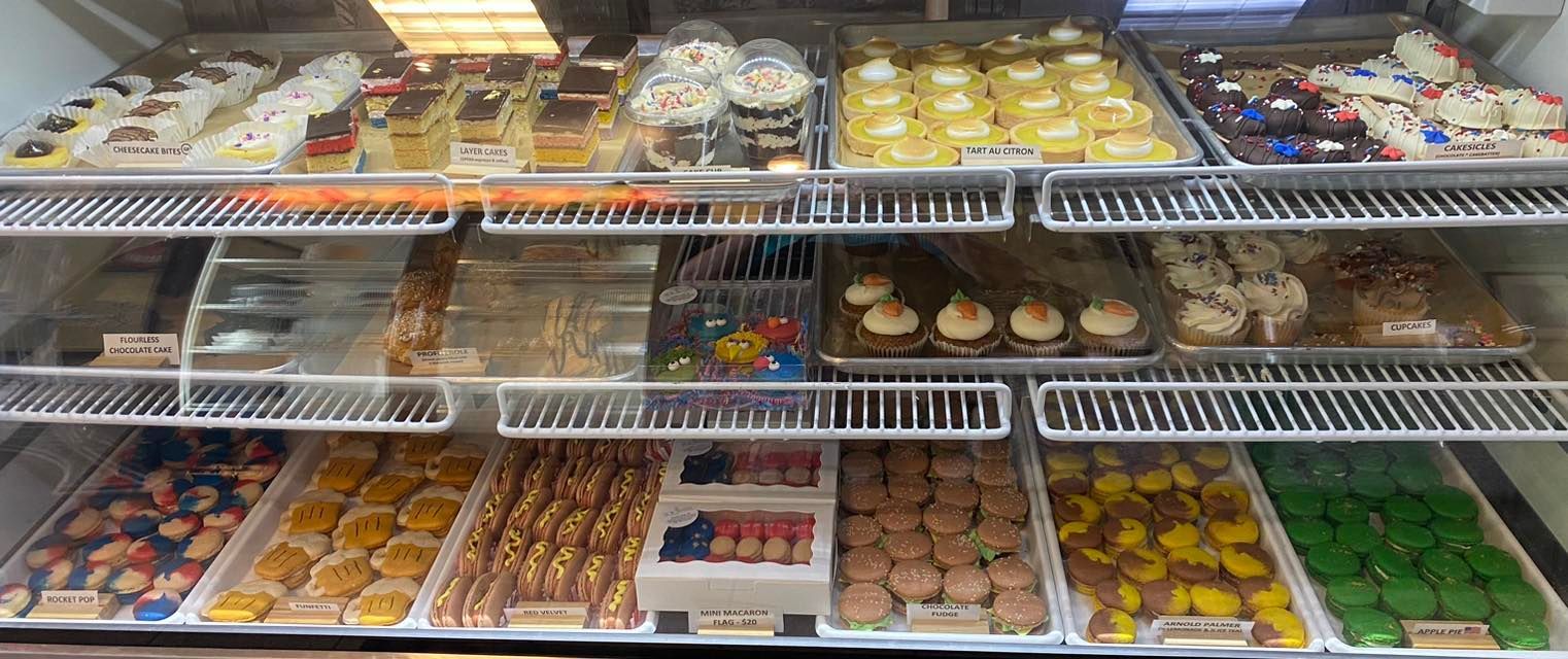 A bakery display case filled with a variety of pastries.