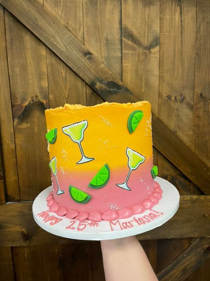 Cake decorated with margarita glasses and limes, pink to yellow gradient.