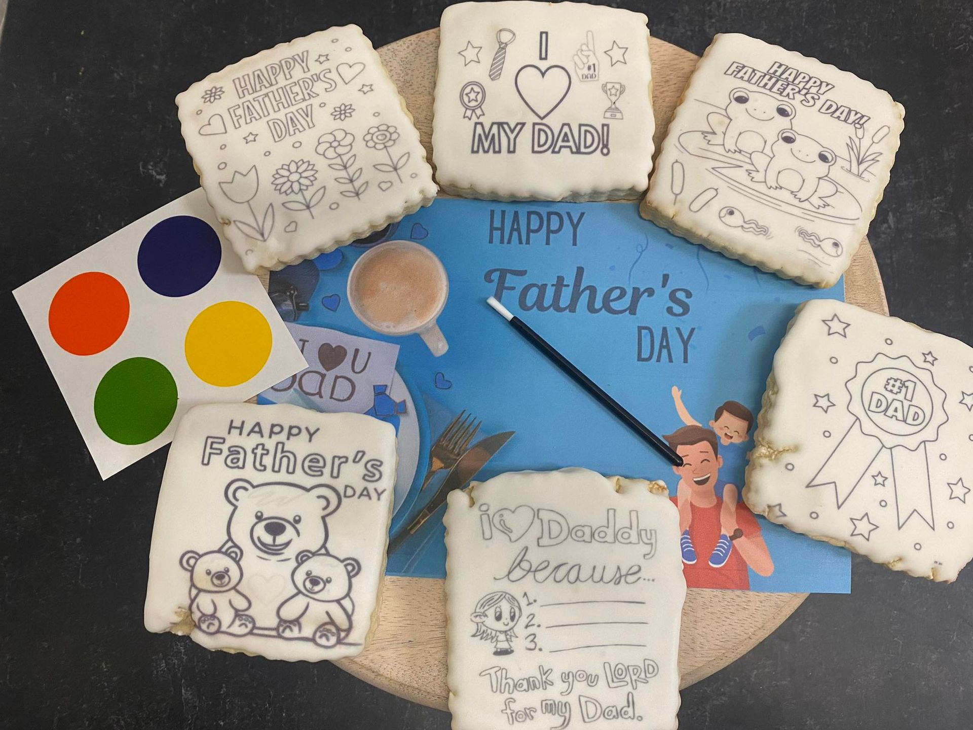 Father's Day cookies with line drawings, a paintbrush, and a card.
