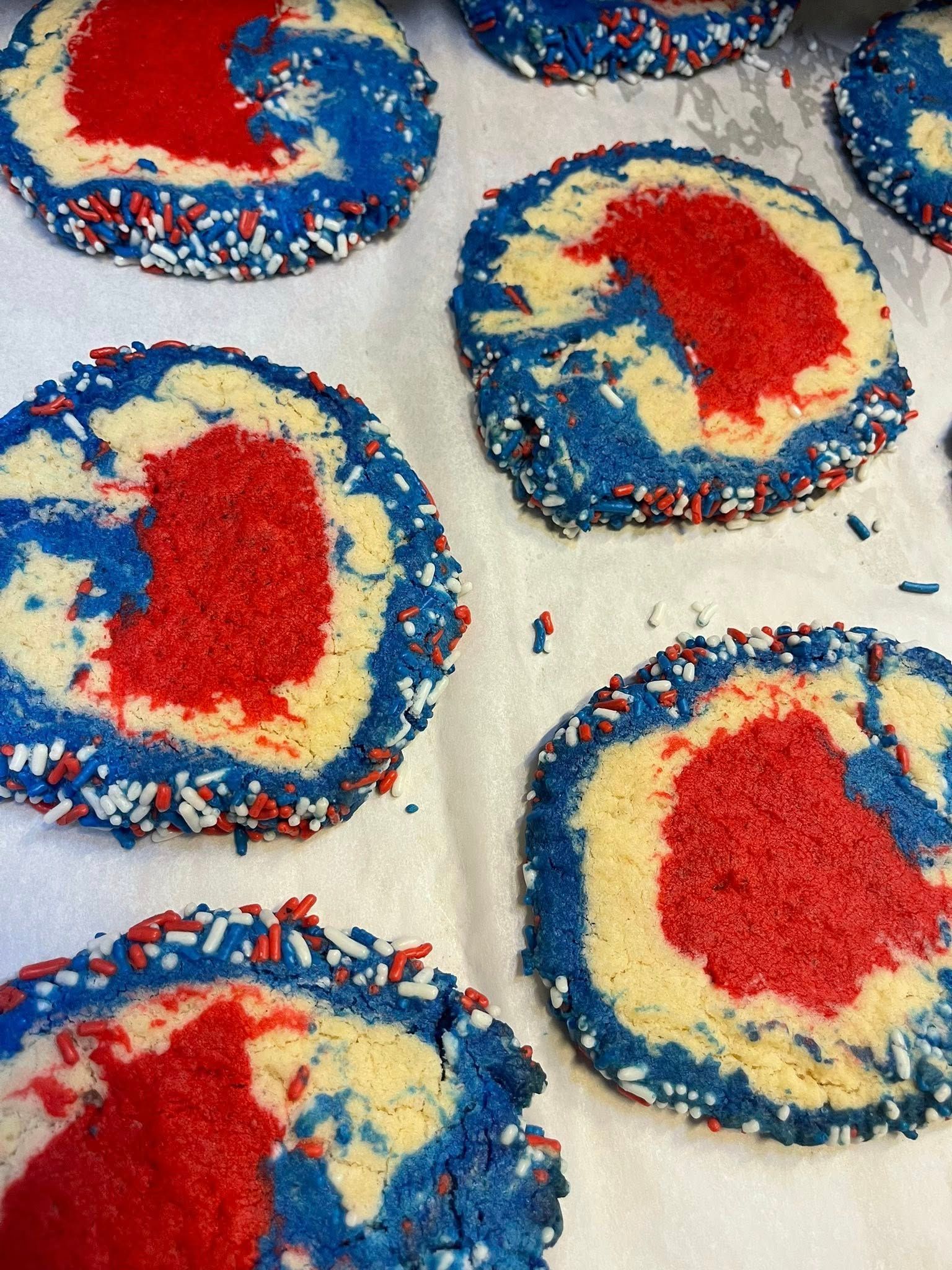 Cookies decorated with red, white, and blue, sprinkled with red, white, and blue sprinkles.