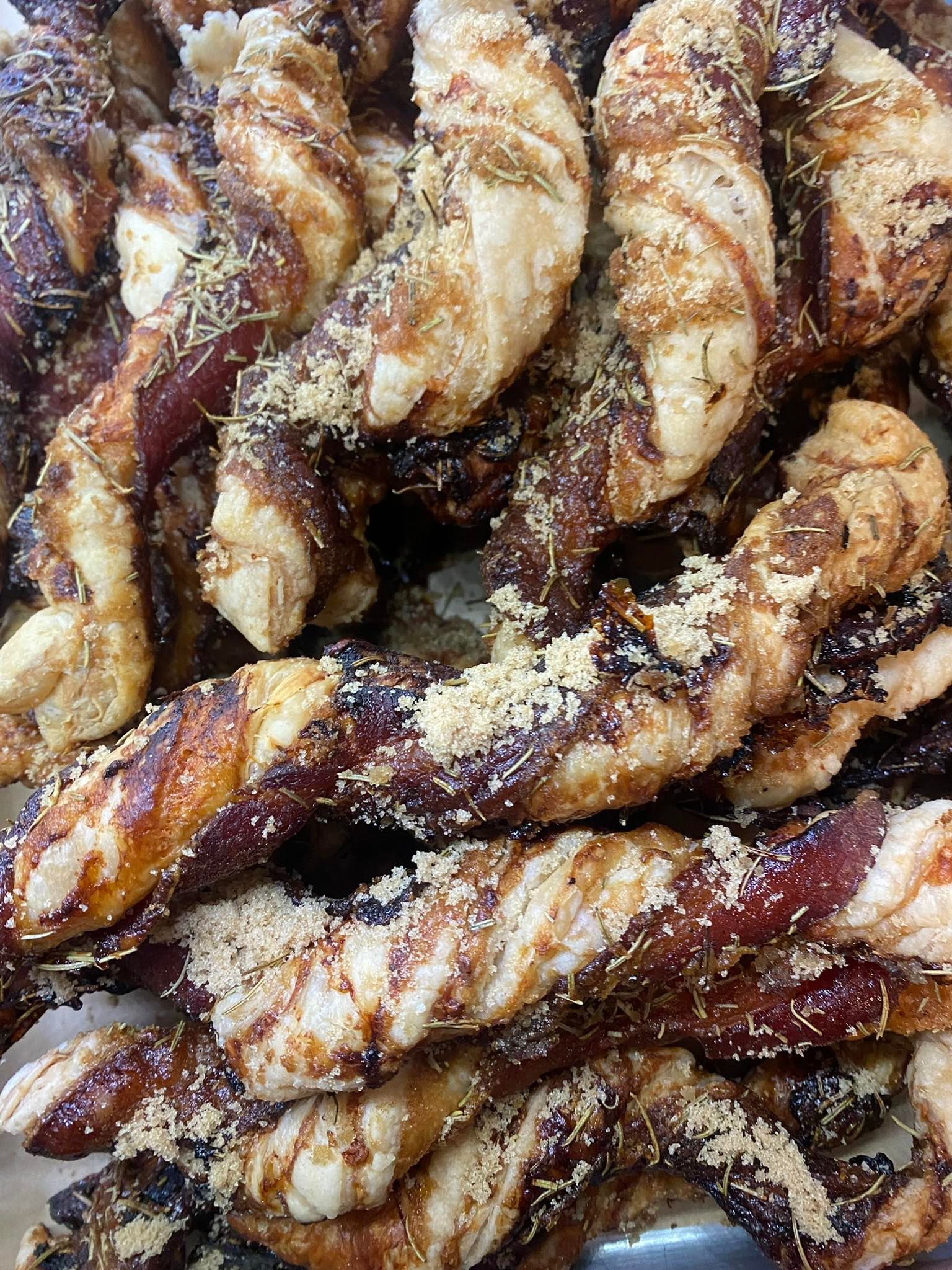 Twisted pastries, brown and tan, sprinkled with crumbs.