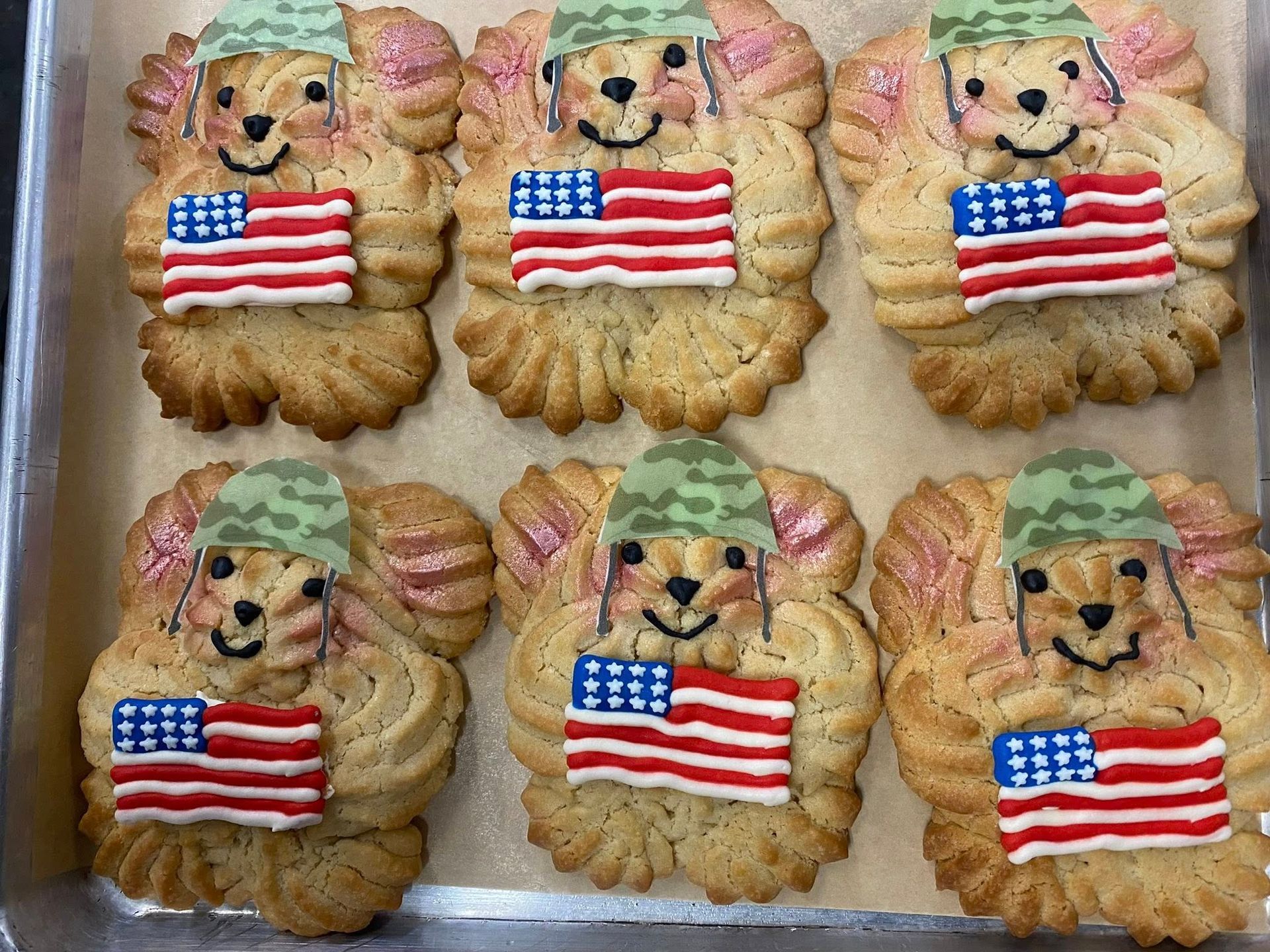 Cookies shaped like dogs, decorated with US flags and army hats.