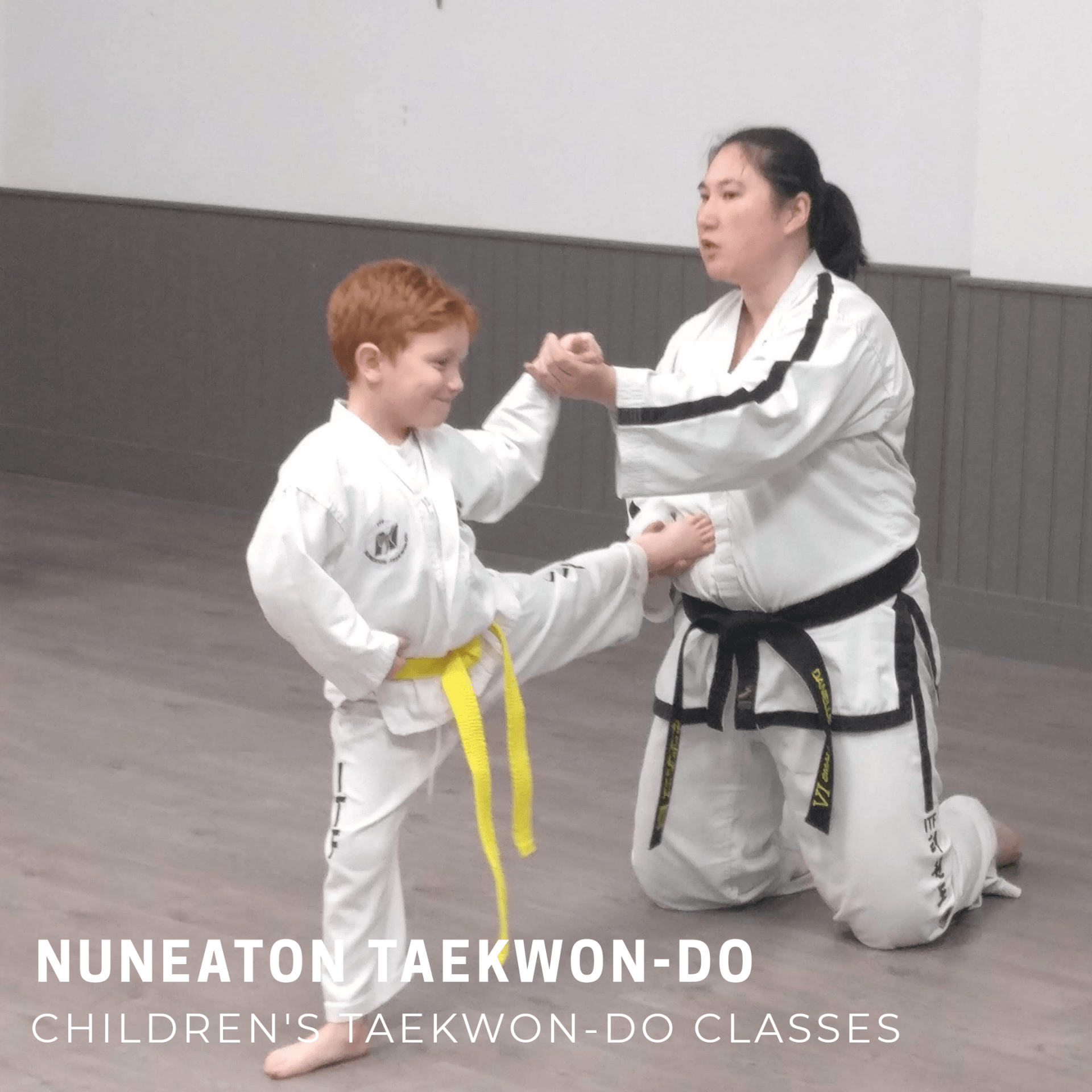 Child kicking and instructor holding leg