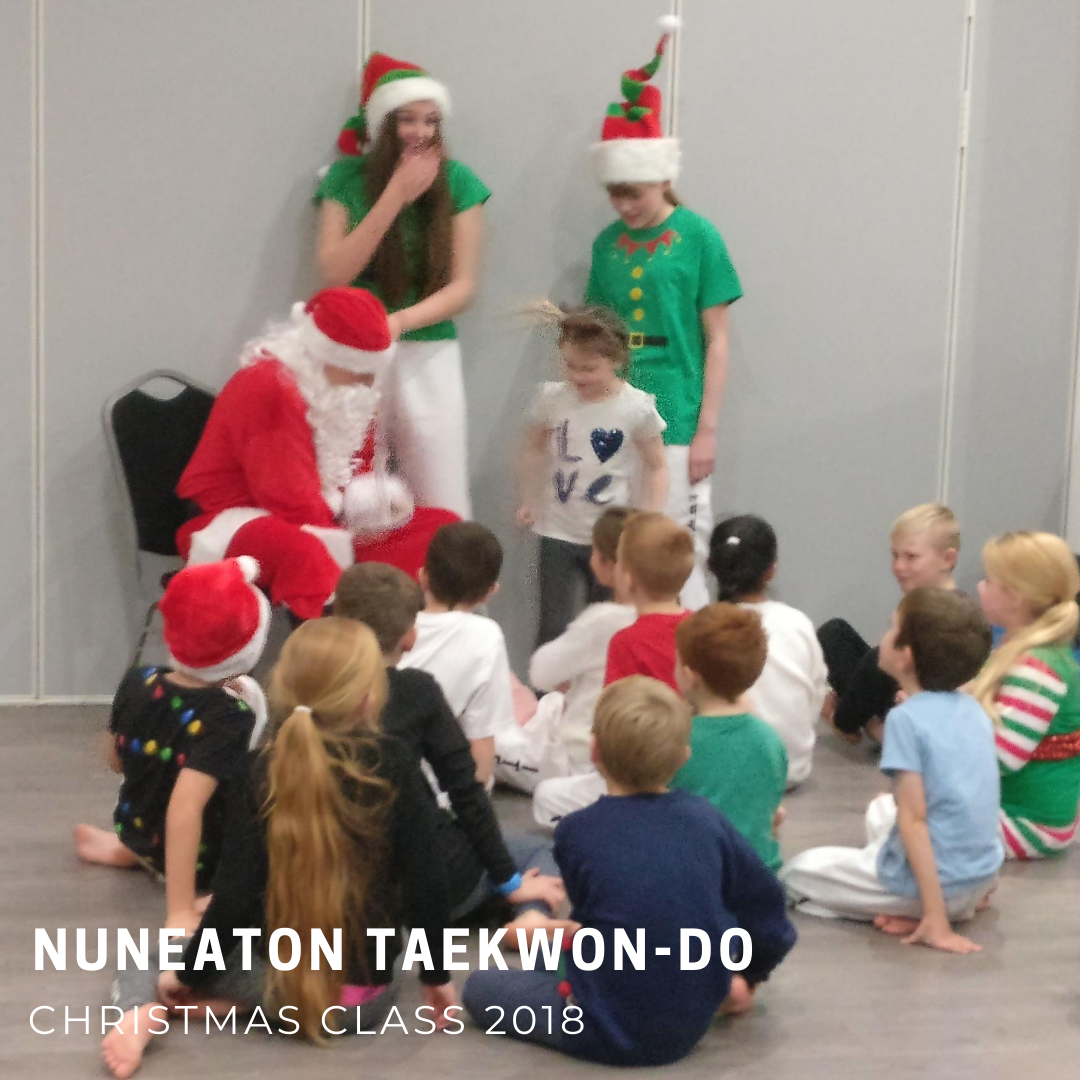 Children wearing Christmas jumper meeting Santa