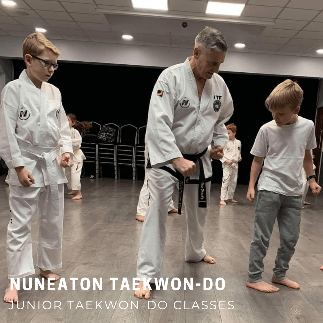 Blackbelt teaching young boy block
