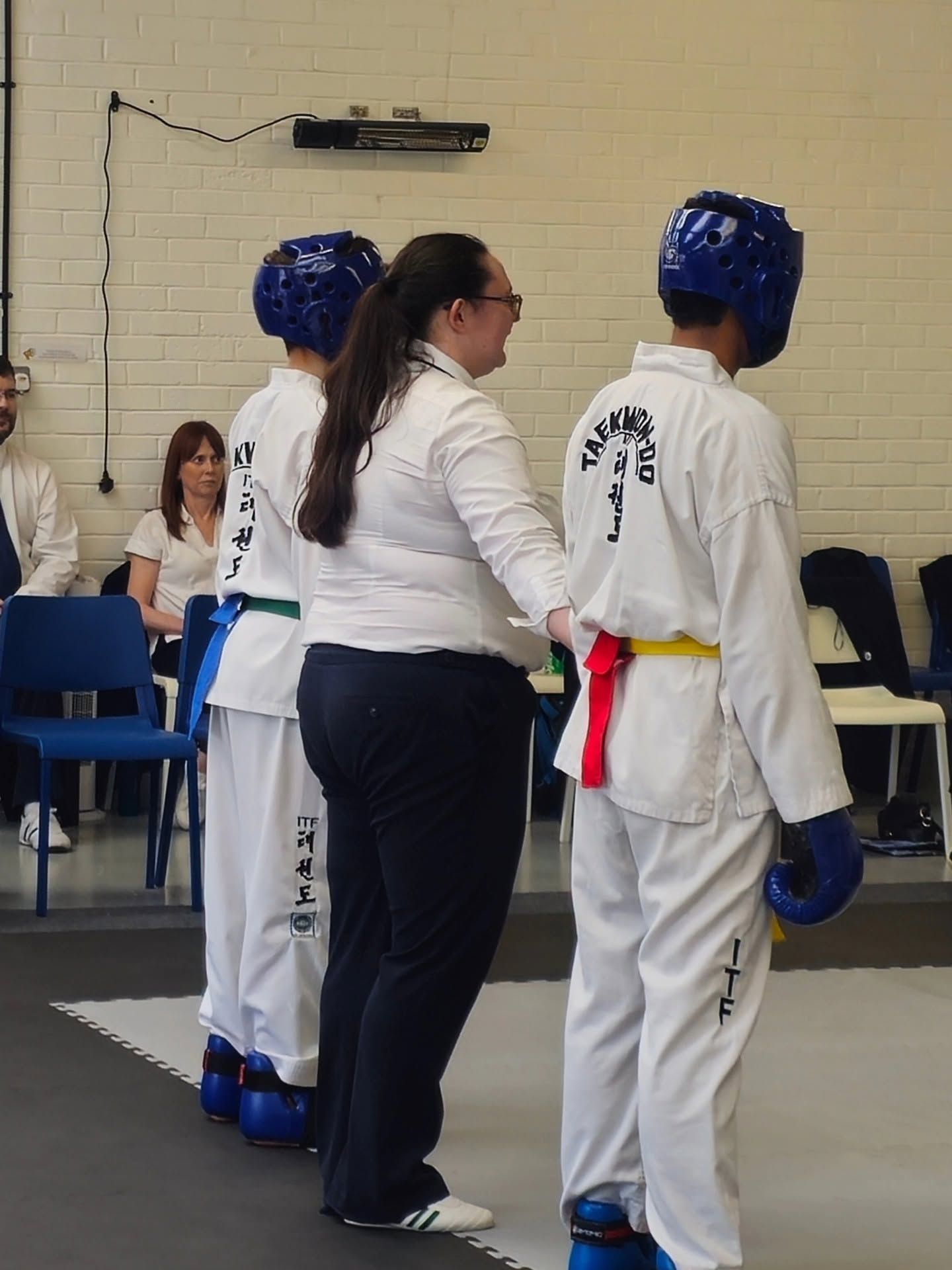 Umpire standing between two competitors
