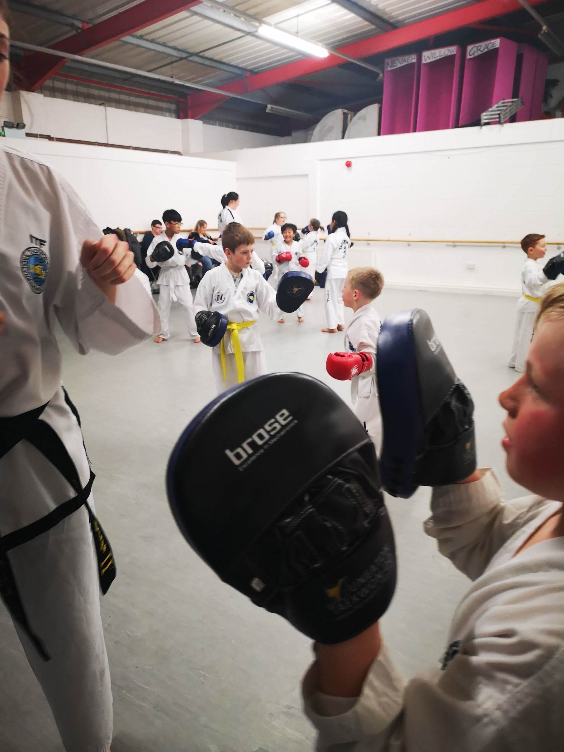 Close up of child holding pads