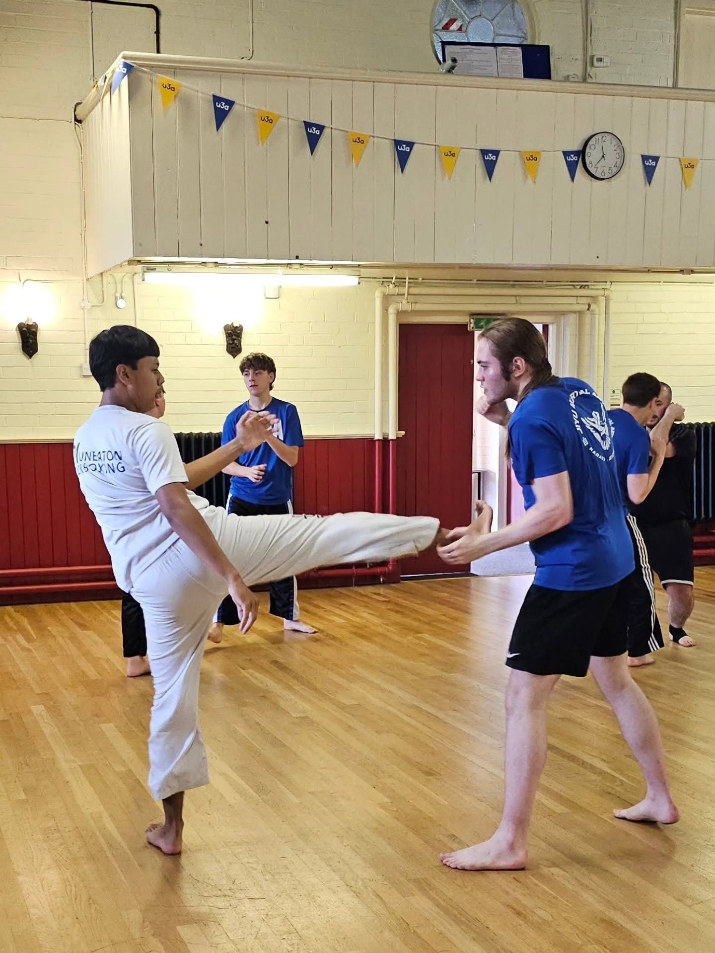 One person front kicking another