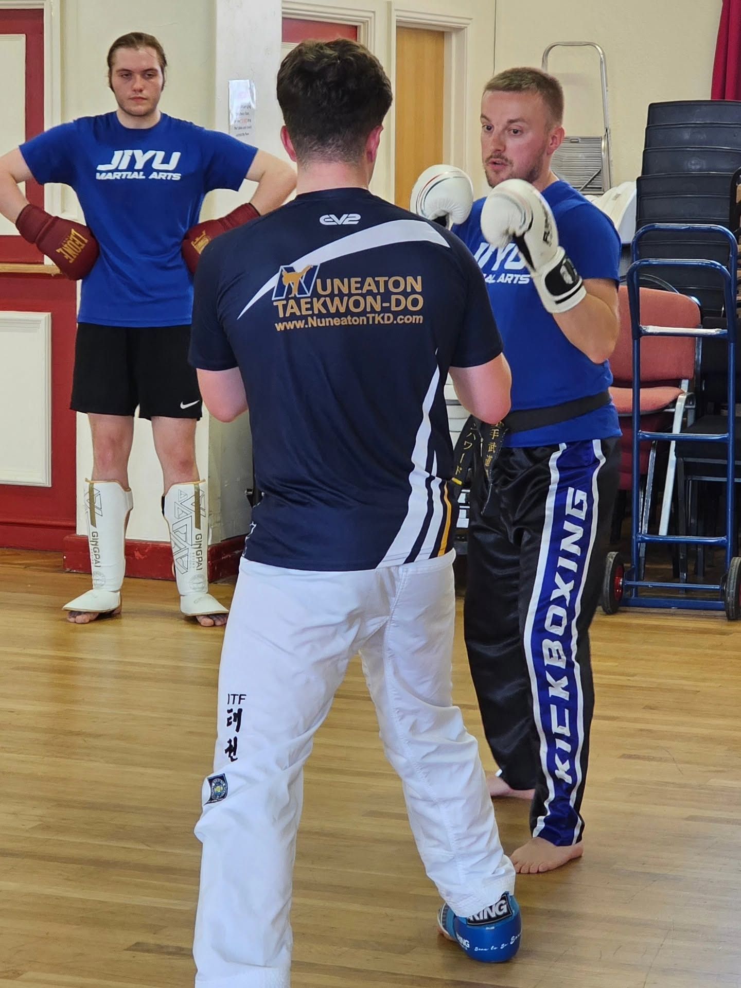 Two students facing each other with boxing gloves