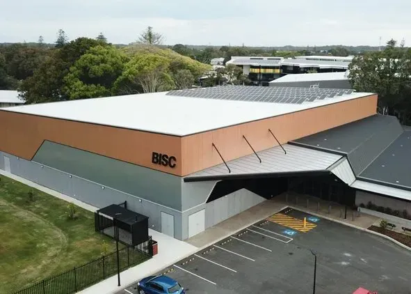 An aerial view of the BISC building, a tan and gray rectangular structure.