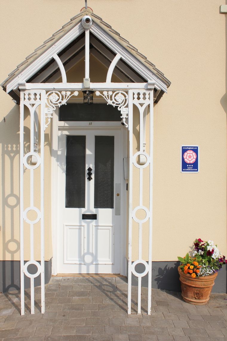 A white door with a canopy on top of it