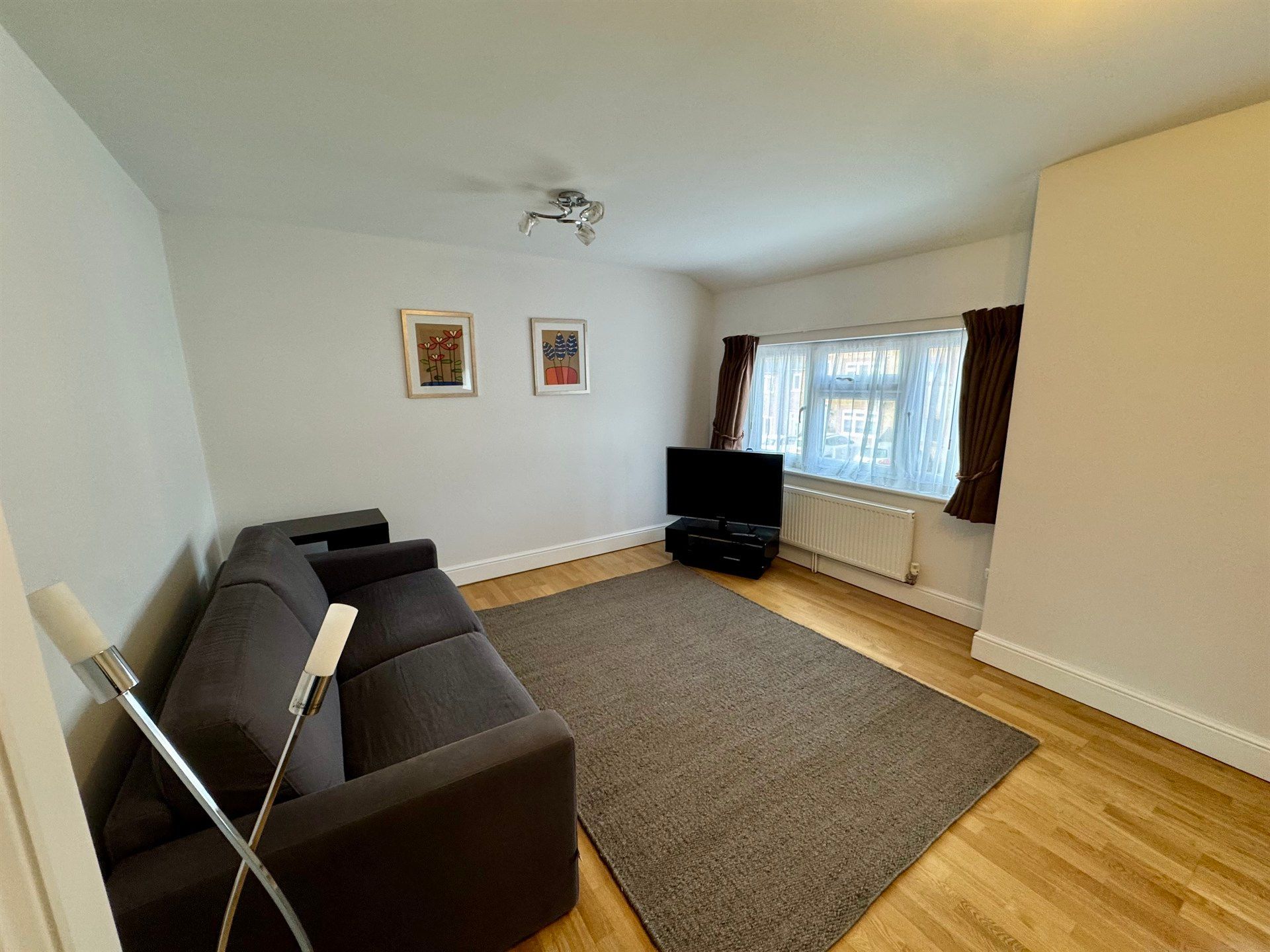 A living room with a couch and a flat screen tv