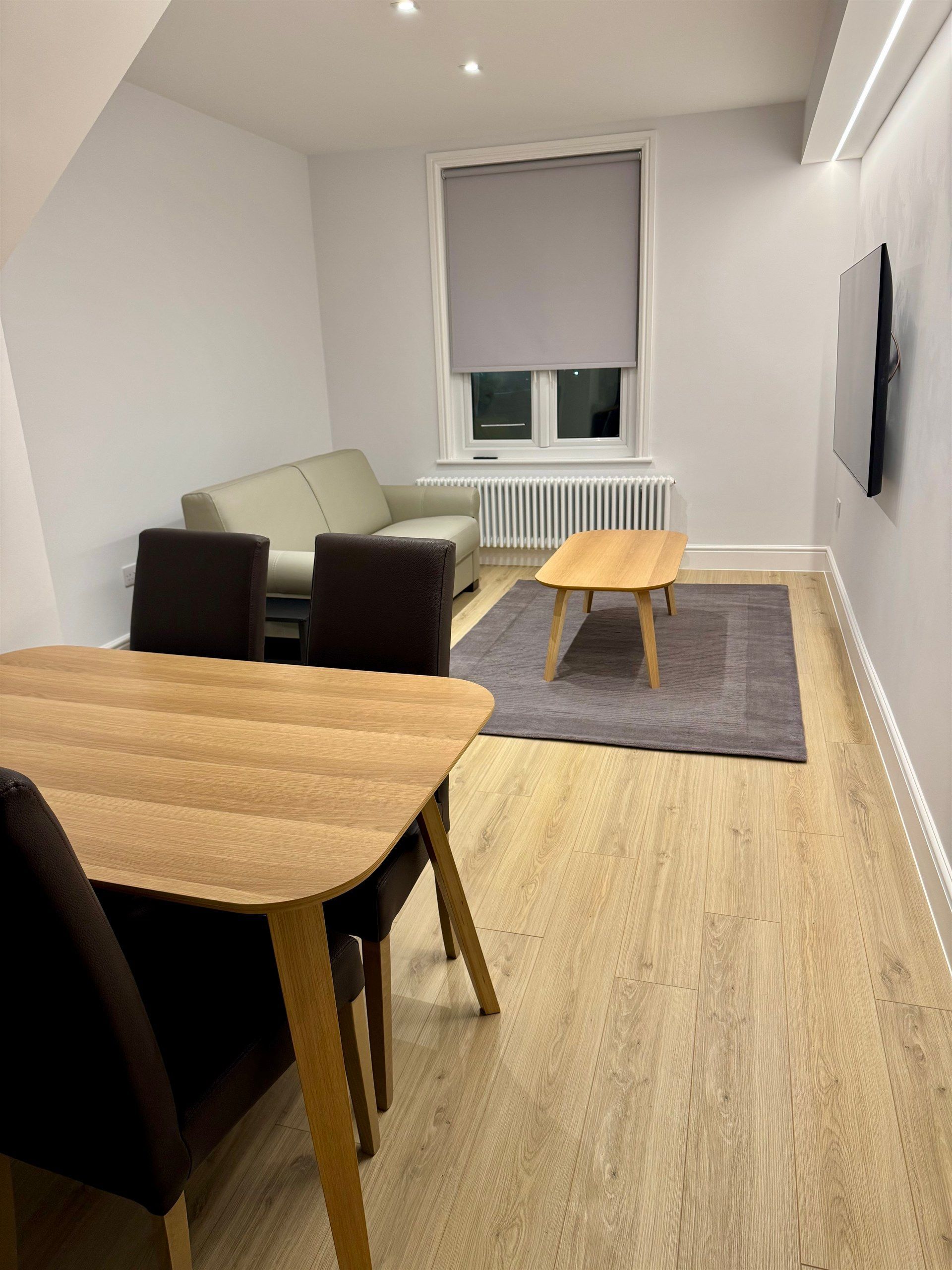 A living room with a table and chairs and a couch