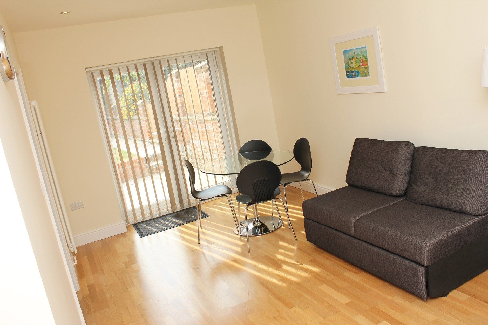 A living room with a couch , table and chairs