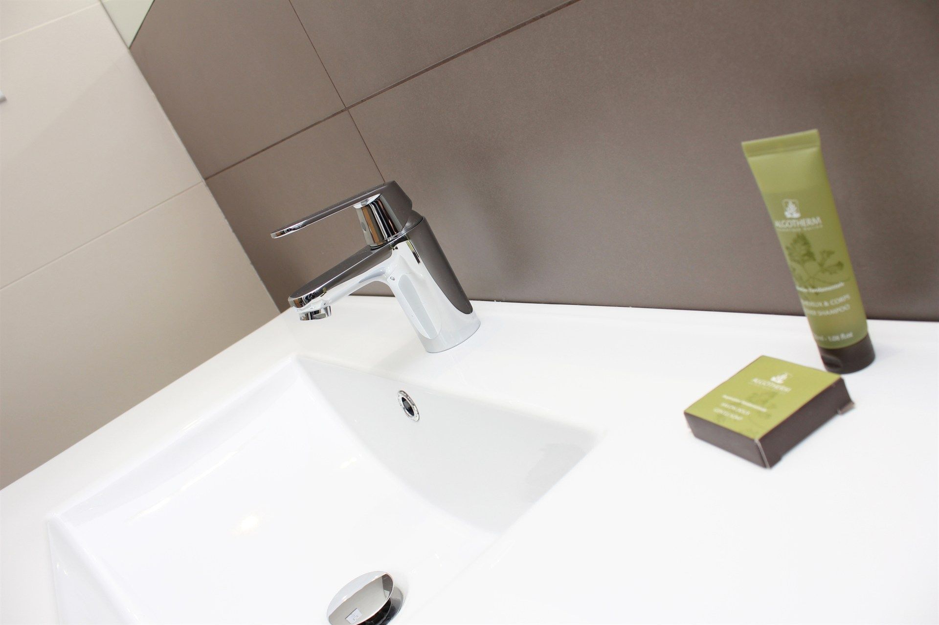 A bathroom sink with a soap and lotion on it
