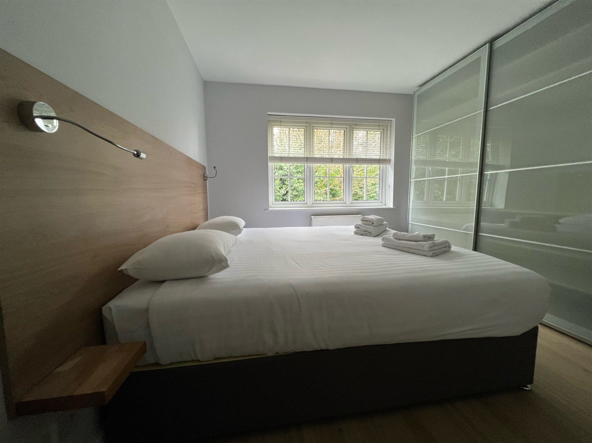 A bedroom with a large bed and a window