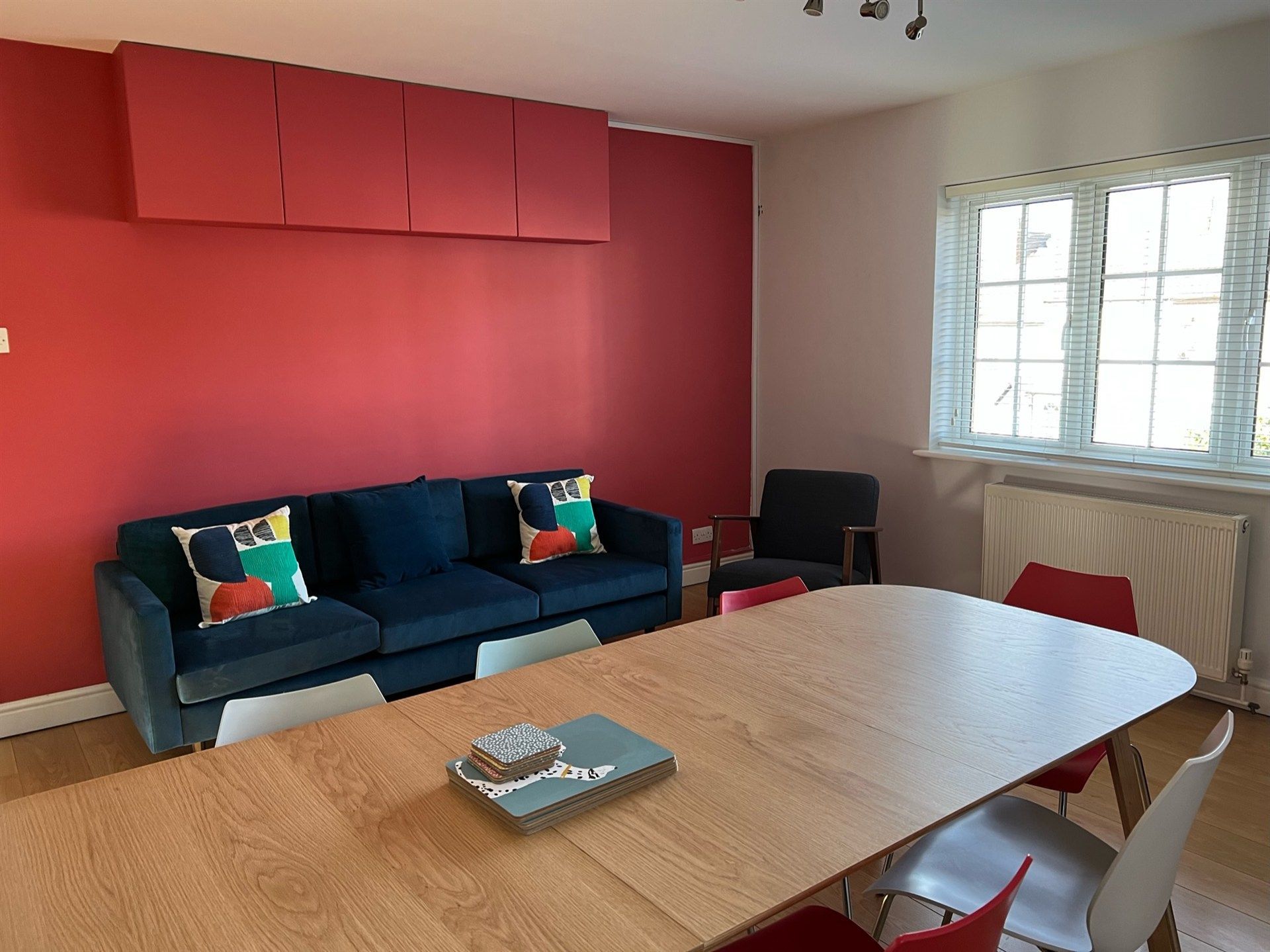 A living room with a couch , table and chairs