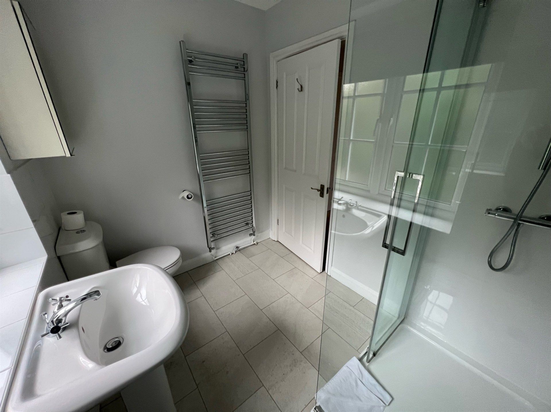 A bathroom with a sink , toilet , and shower.