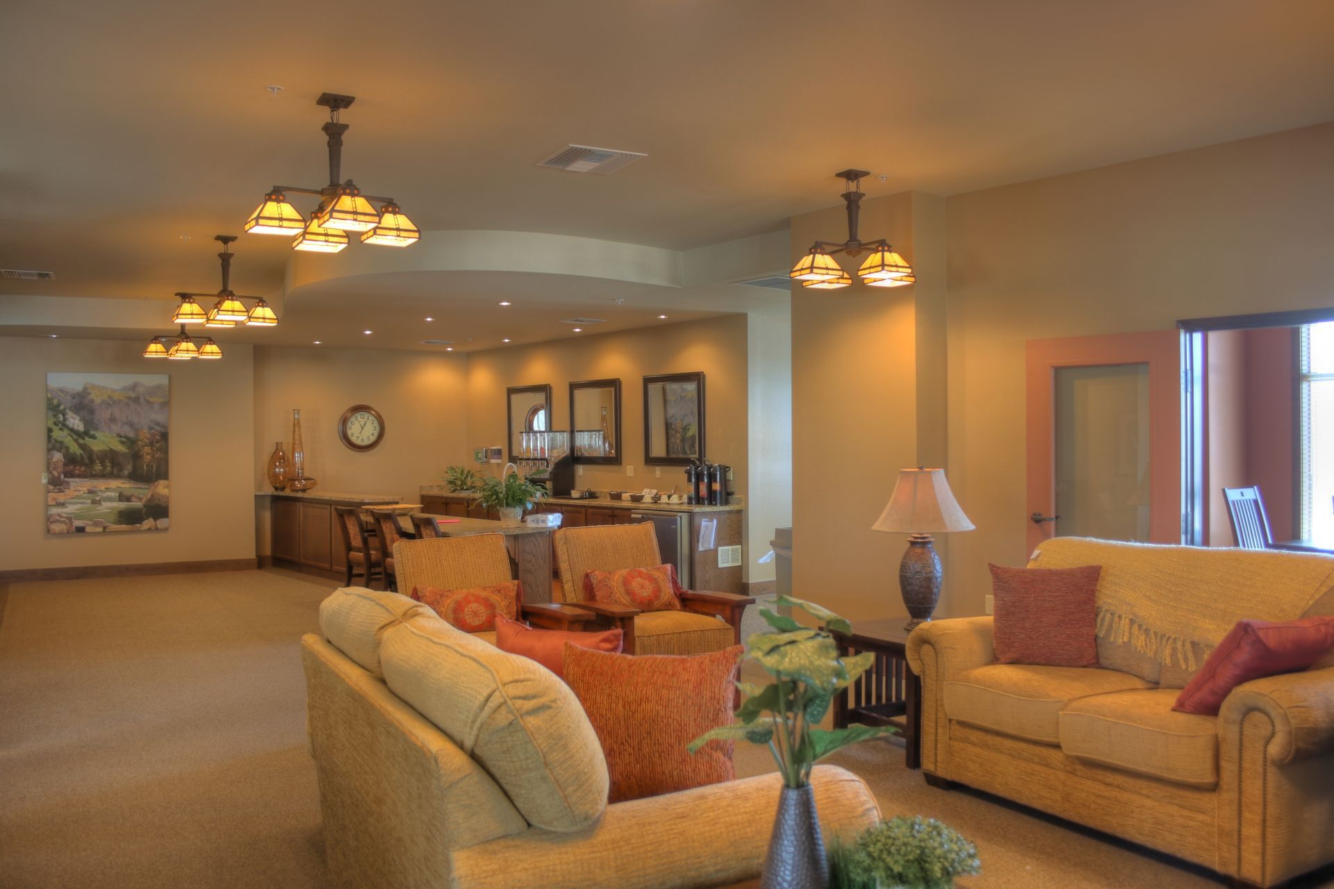 A living room with a couch , chairs and lamps