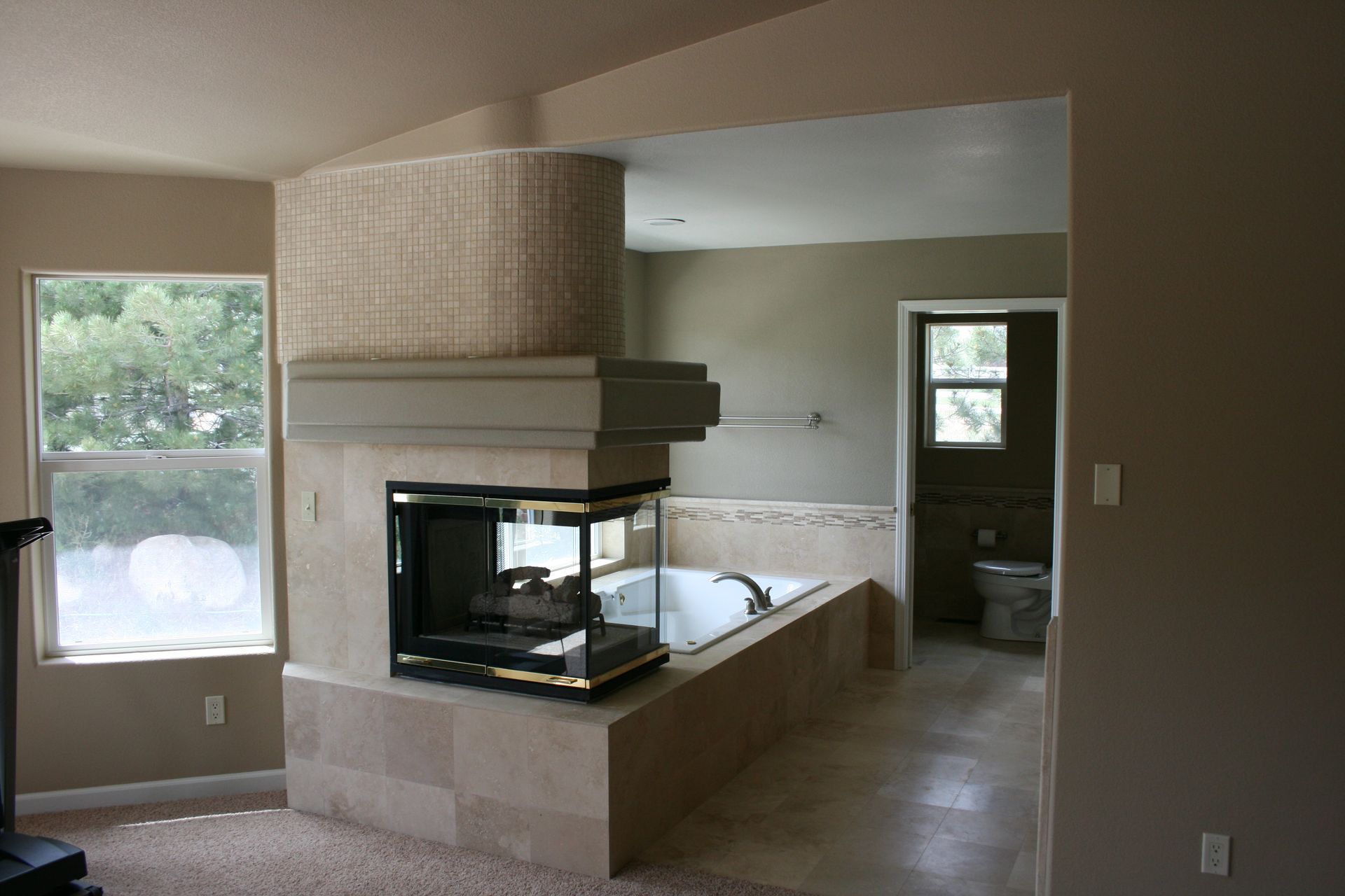 A living room with a fireplace and a bathtub