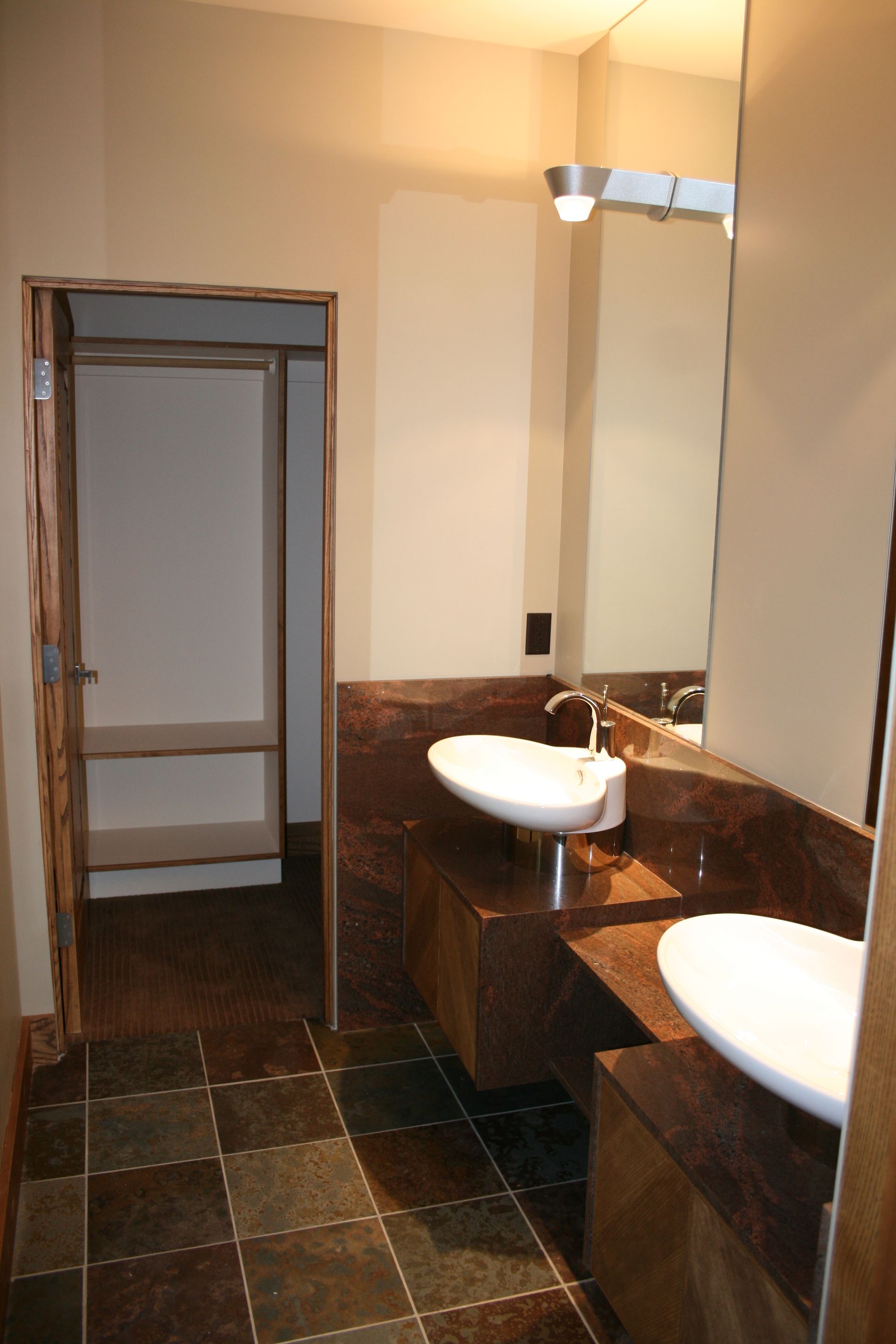 A bathroom with two sinks and a mirror