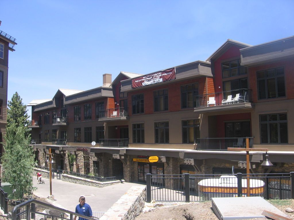 A man stands in front of a building with a sign that says ' kings ' on it