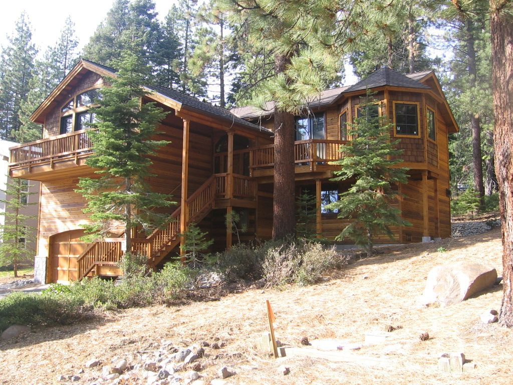 A large log cabin in the middle of a forest
