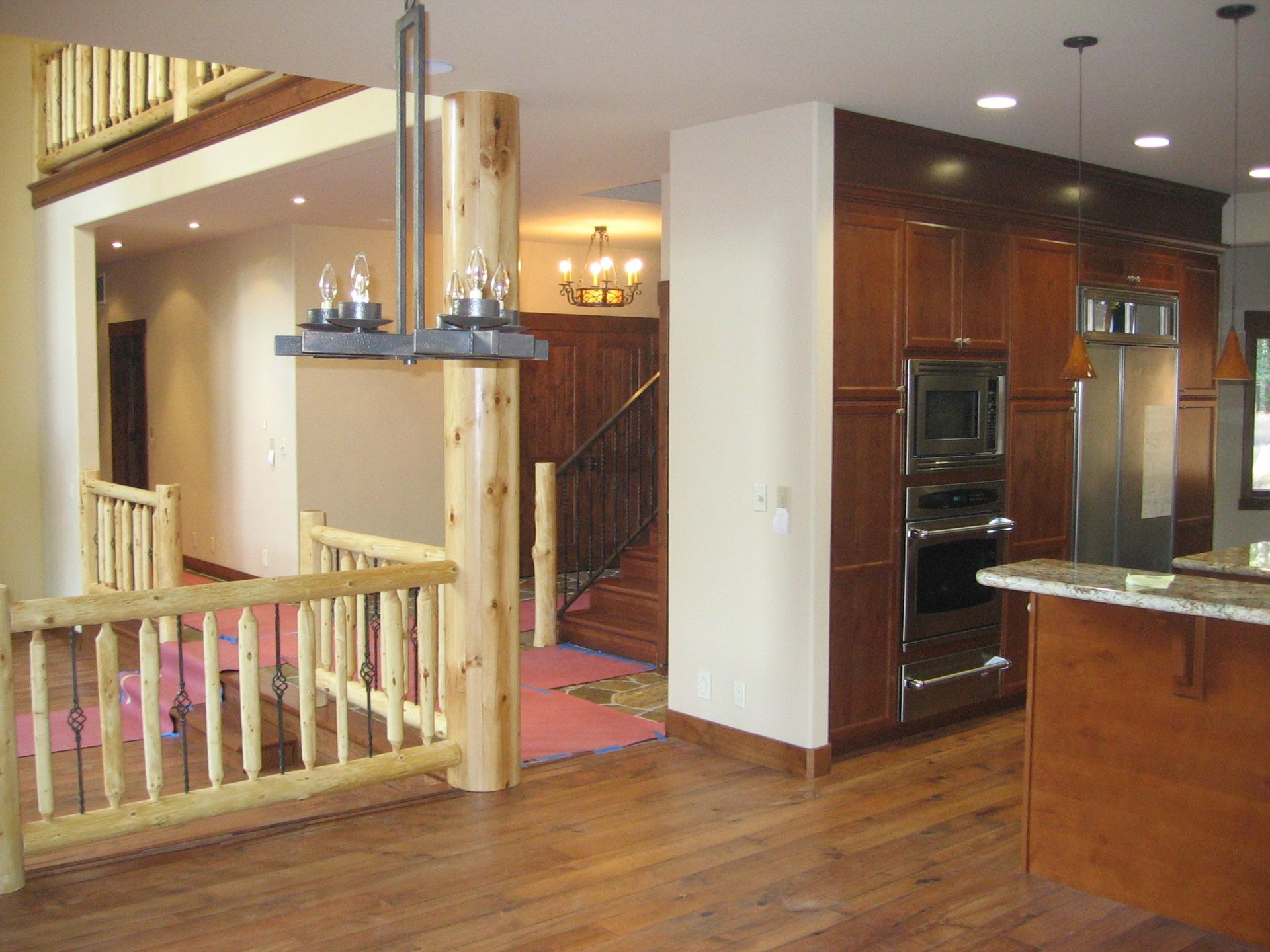 A kitchen with stainless steel appliances and wooden cabinets