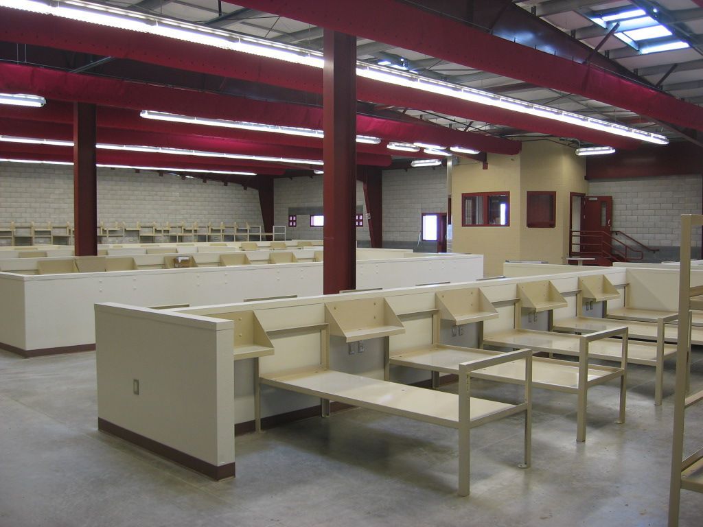 A large room with a lot of benches and tables