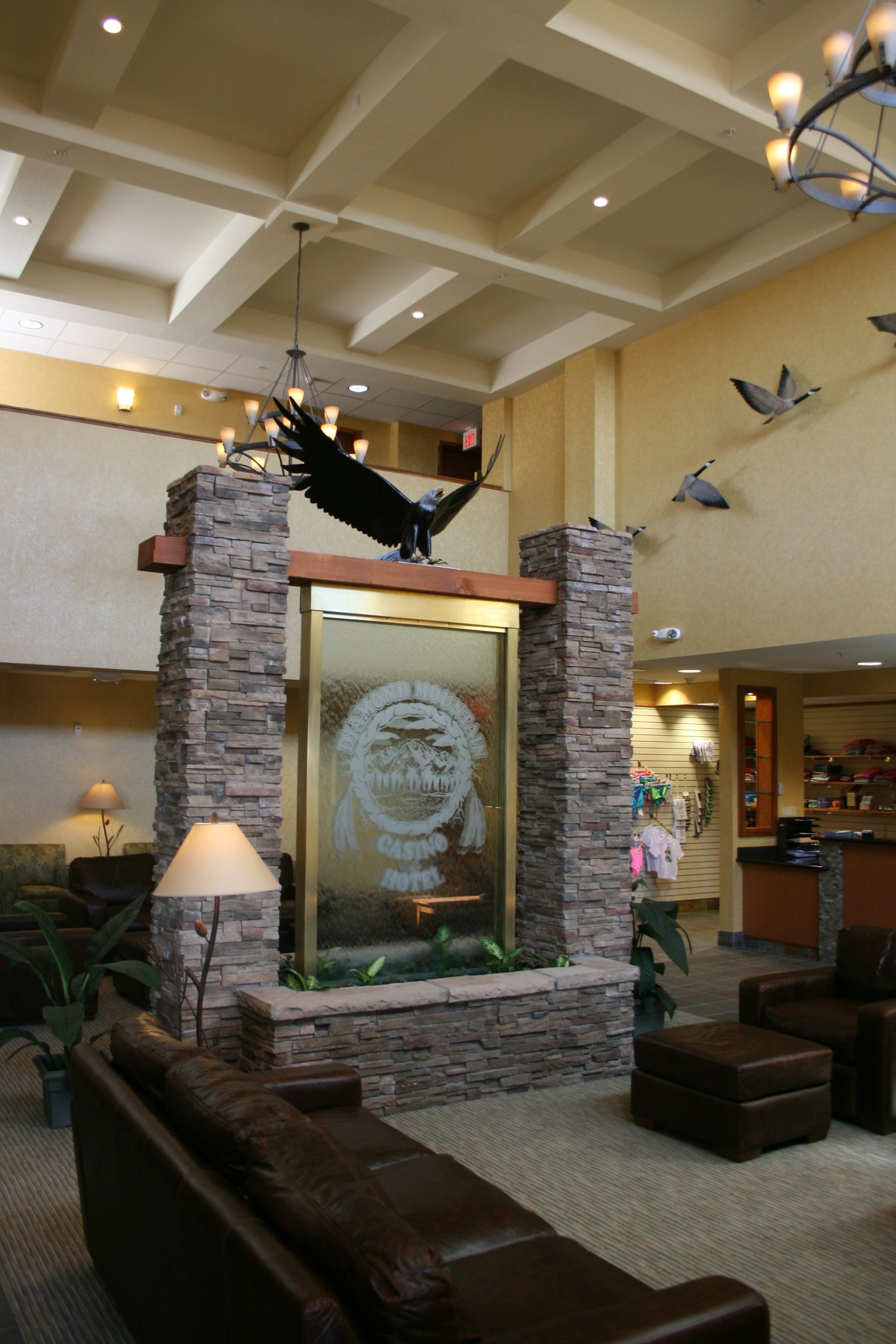 A hotel lobby with a statue of an eagle on top of a stone pillar
