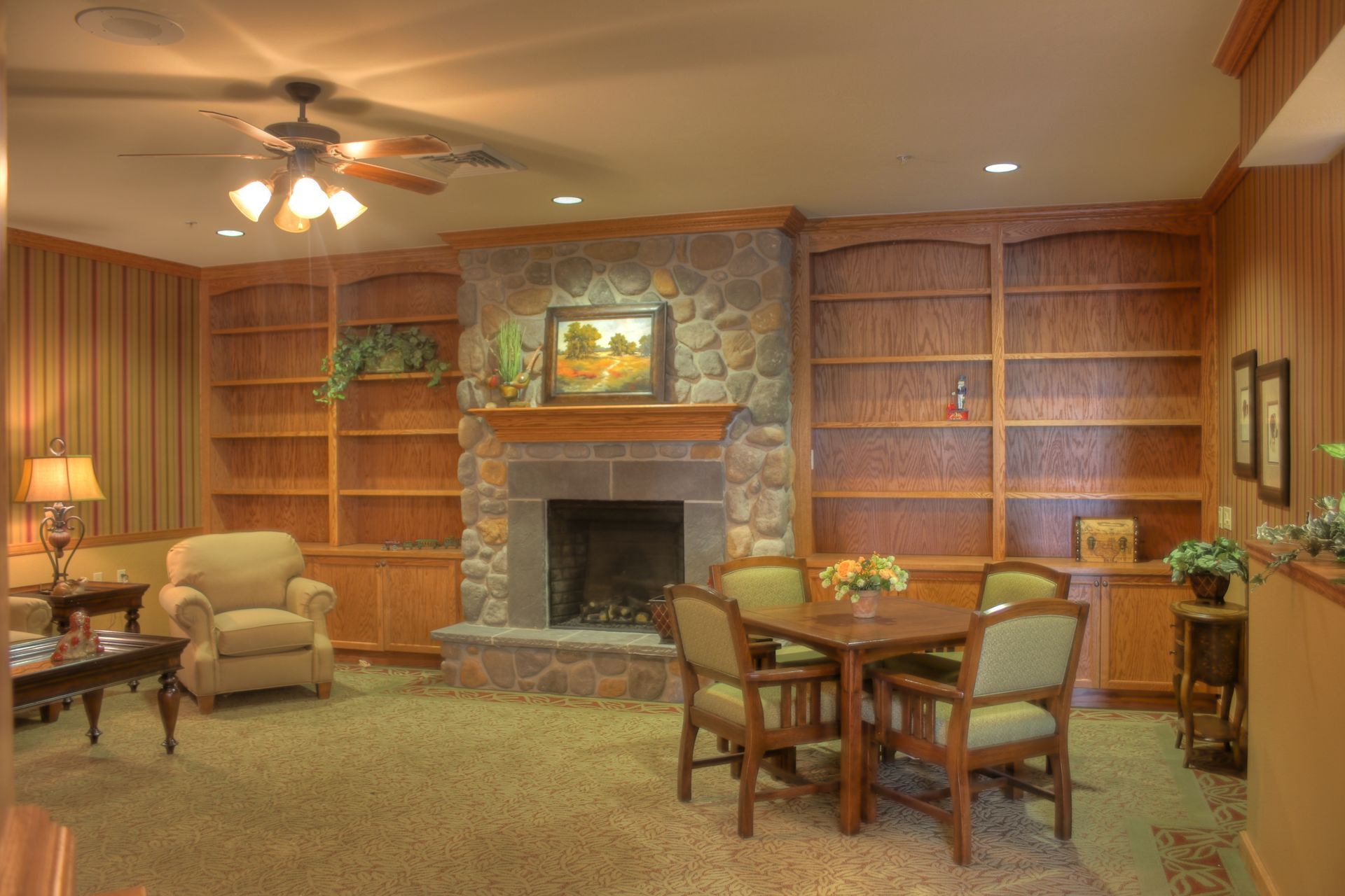 A living room with a fireplace , table and chairs.