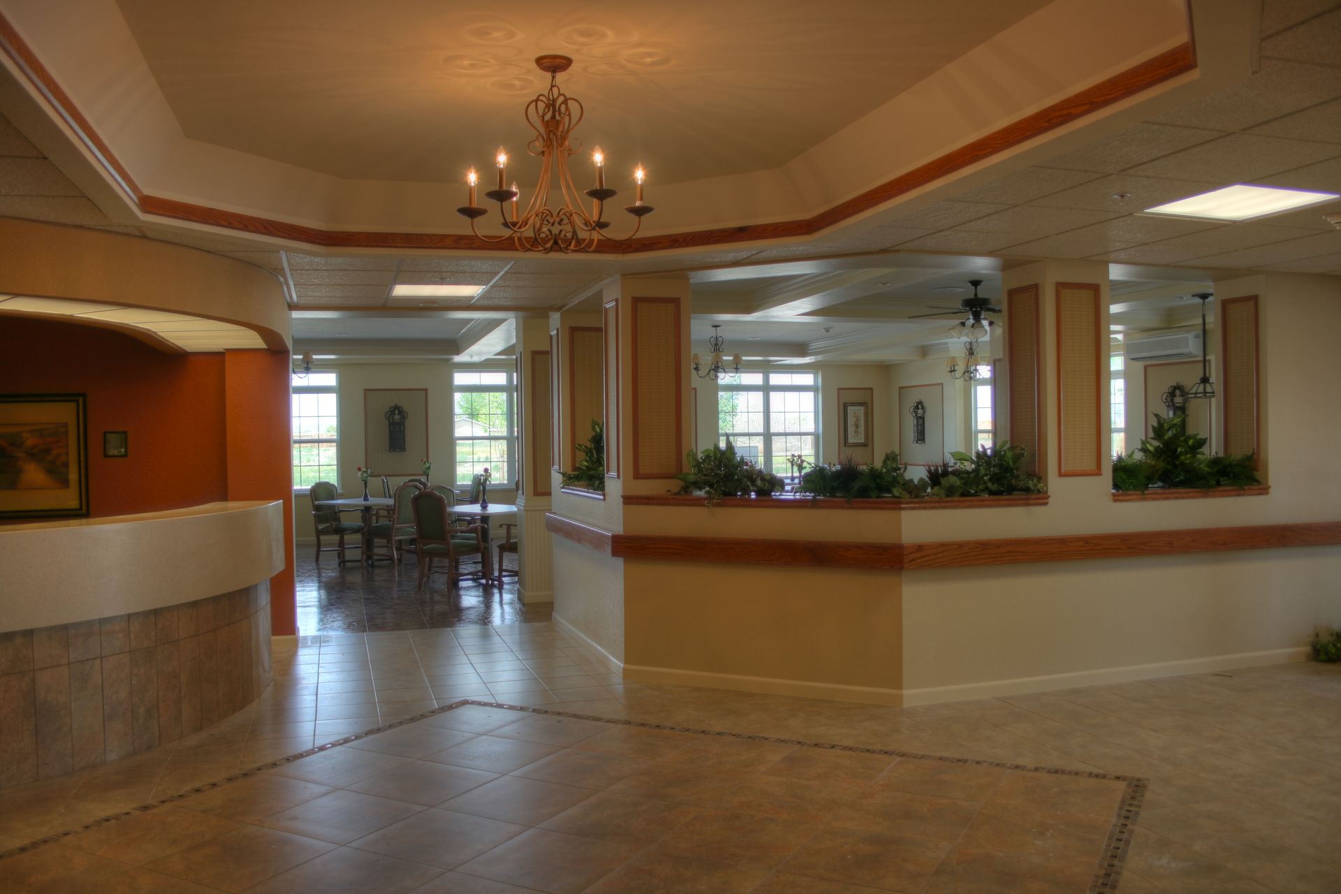 A large empty room with a chandelier hanging from the ceiling.