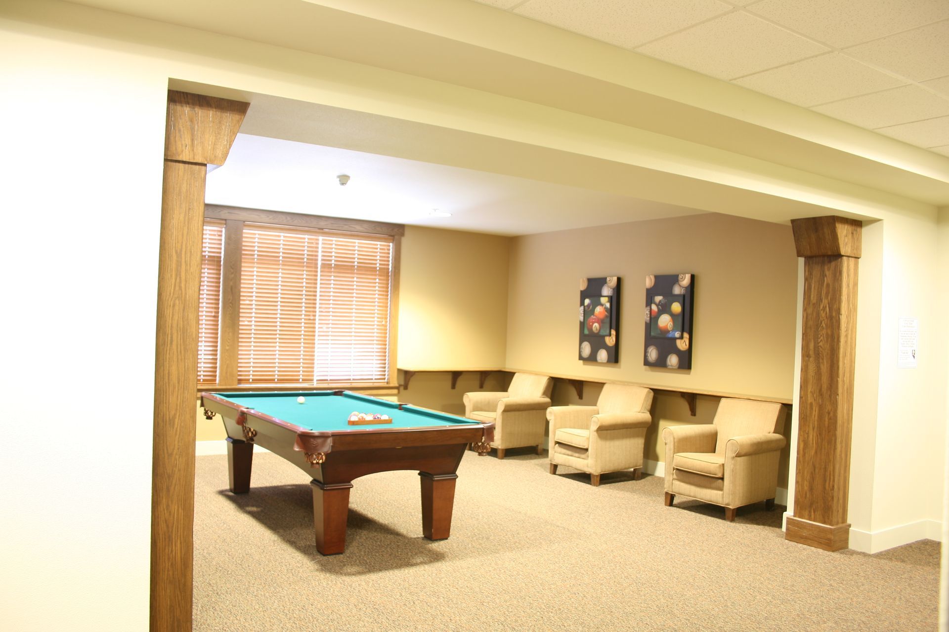 There is a pool table in the middle of the room.