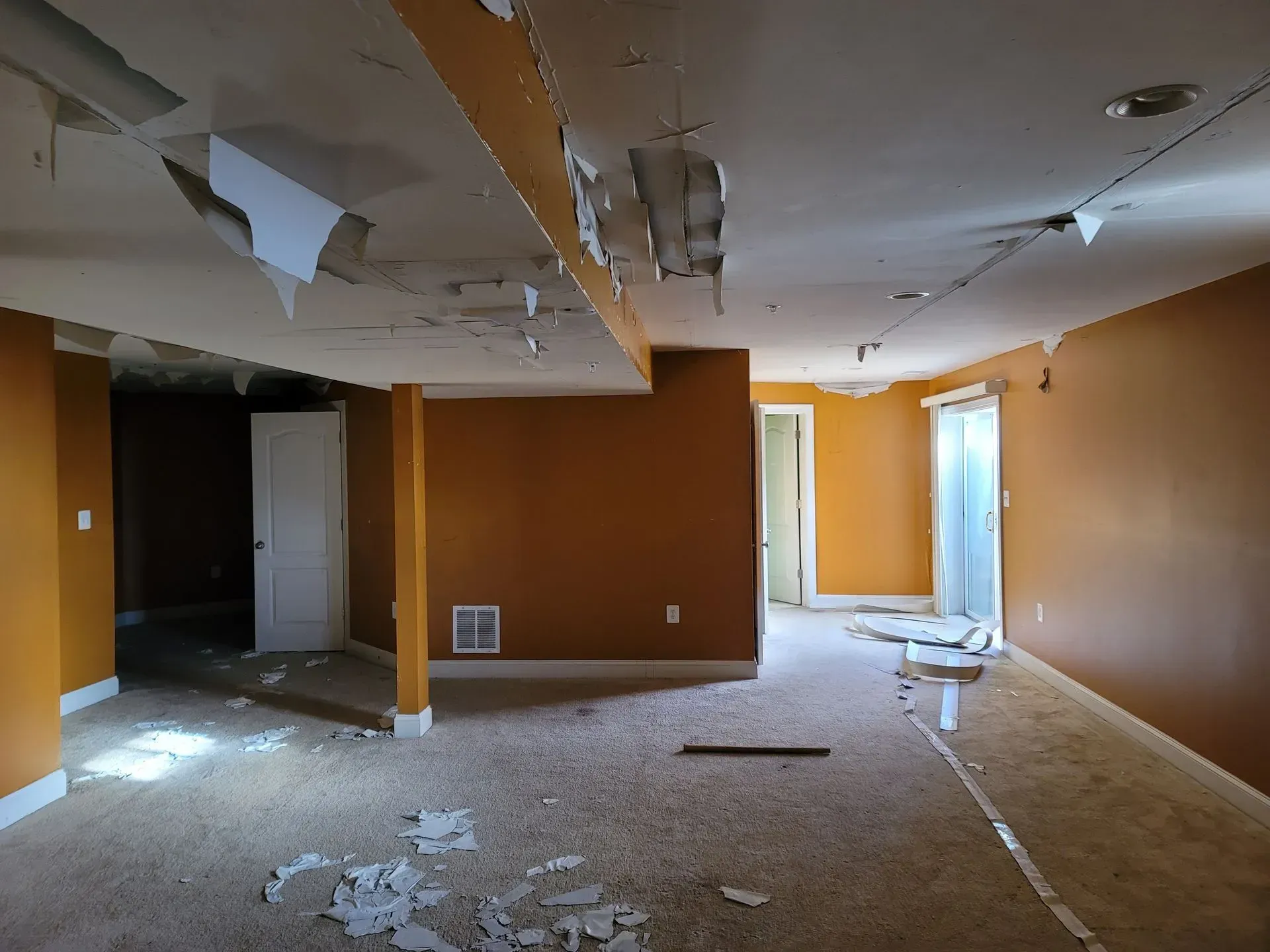 An empty basement with a ceiling that has fallen off