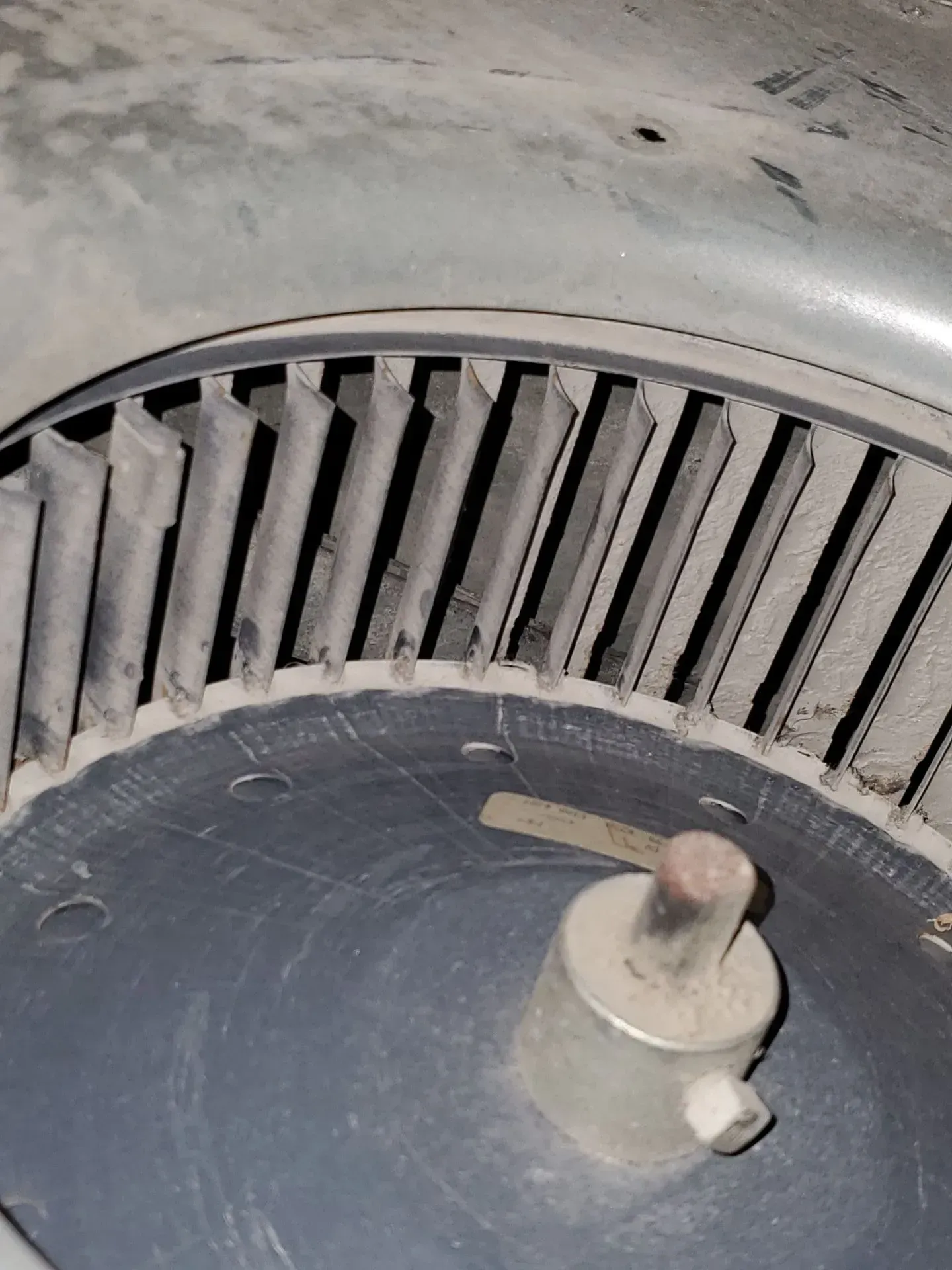 A close up of a dirty air conditioner fan