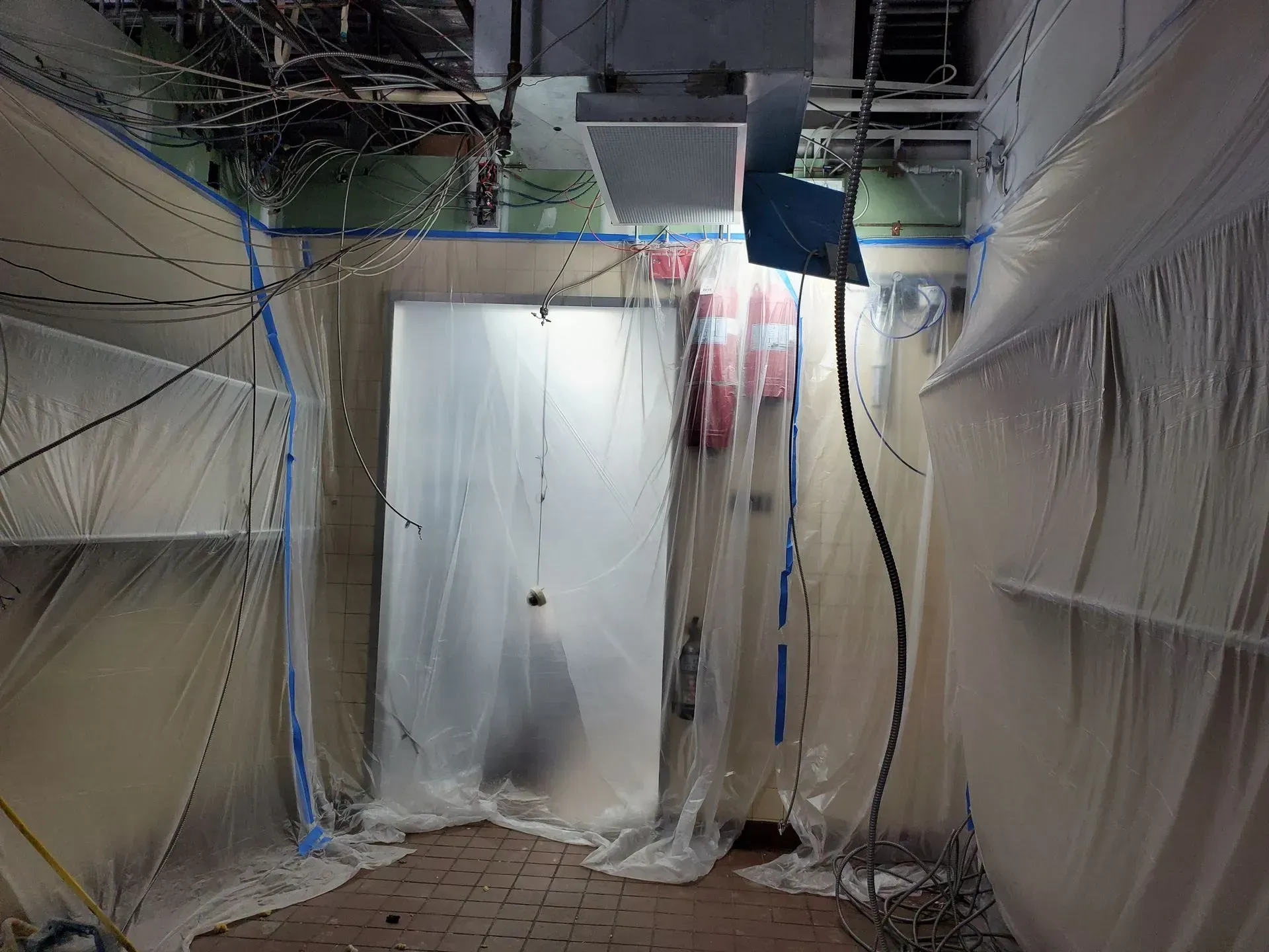 A room with a door that is covered in plastic.