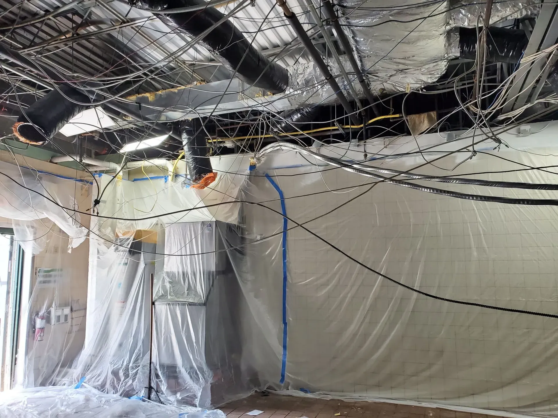 A room with a lot of wires hanging from the ceiling