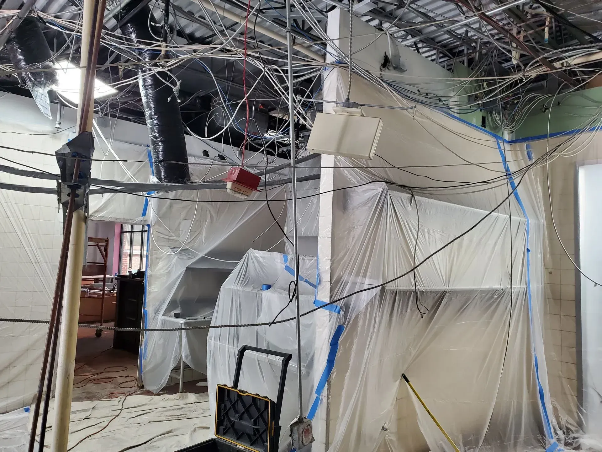 A room with a lot of wires hanging from the ceiling