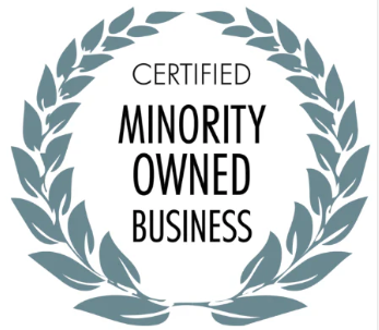 Certified Minority Owned Business emblem featuring black text centered inside a gray circular laurel wreath.