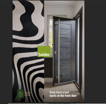 A dark front door slightly ajar with a wood grain effect, a striped rug, and the Solidor logo.