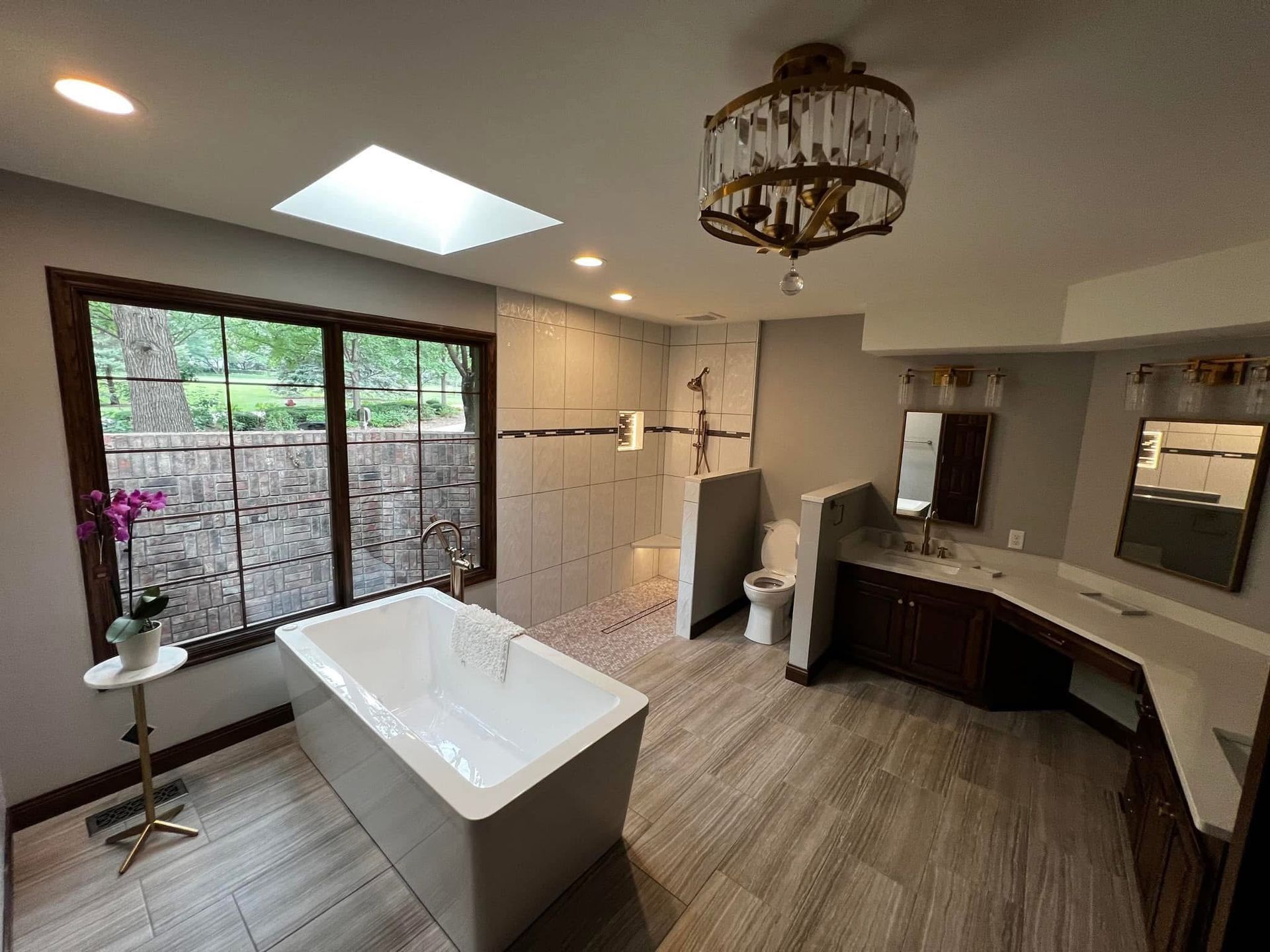 A set of wooden stairs leading up to a deck with a black railing.