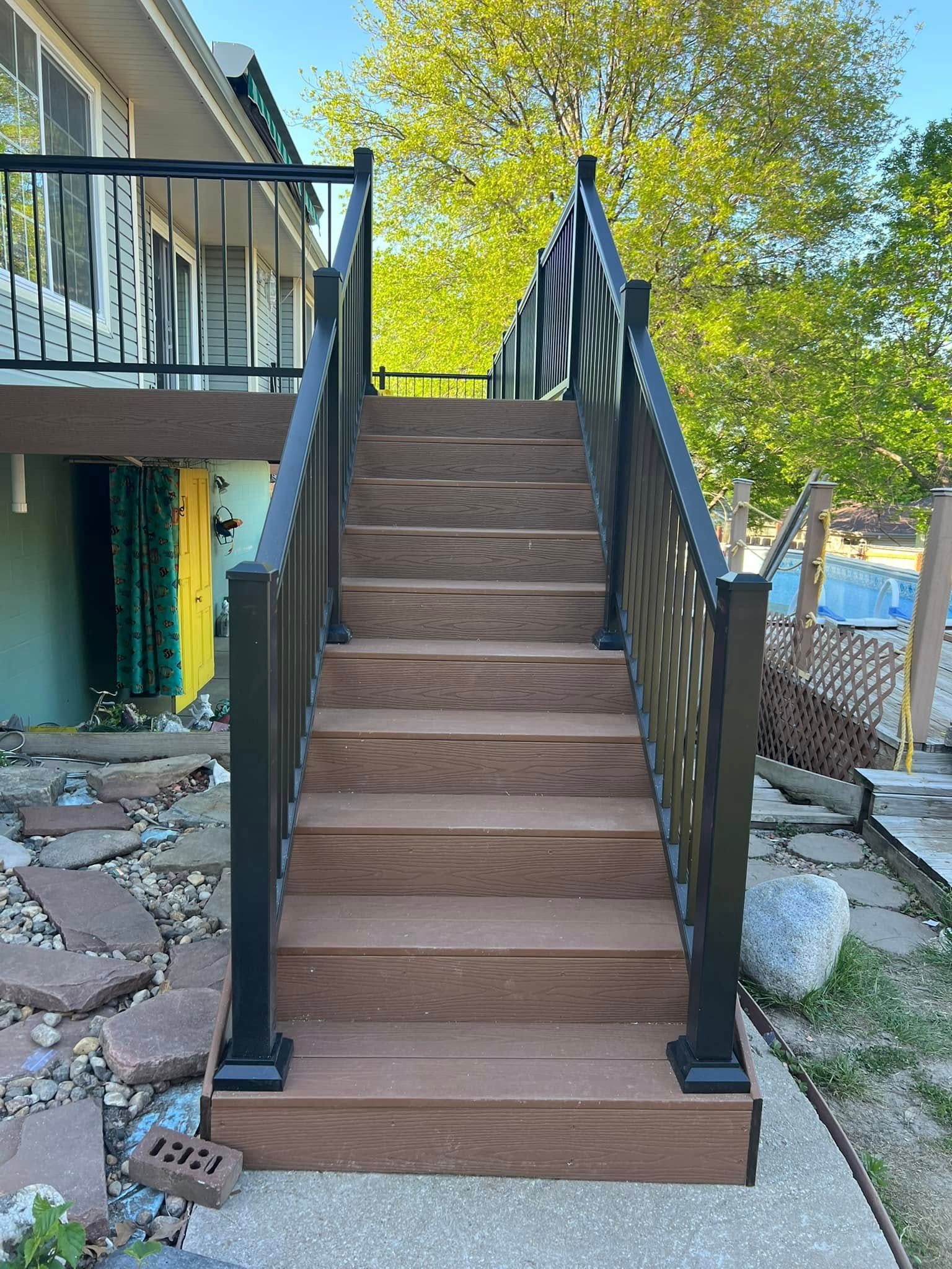 A curved staircase in a house with a vase of flowers on a table.