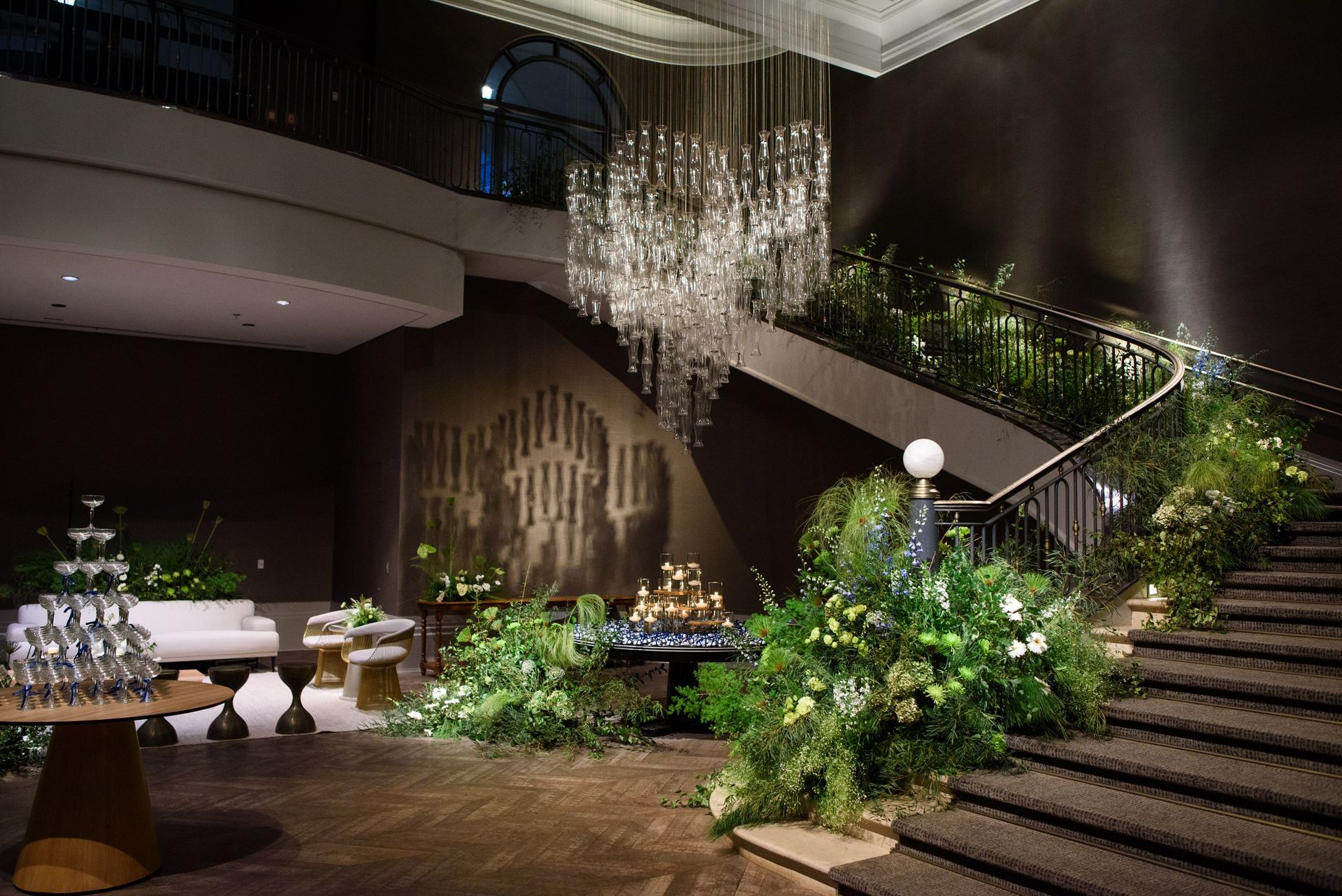 Há um grande lustre pendurado no teto acima da escada.